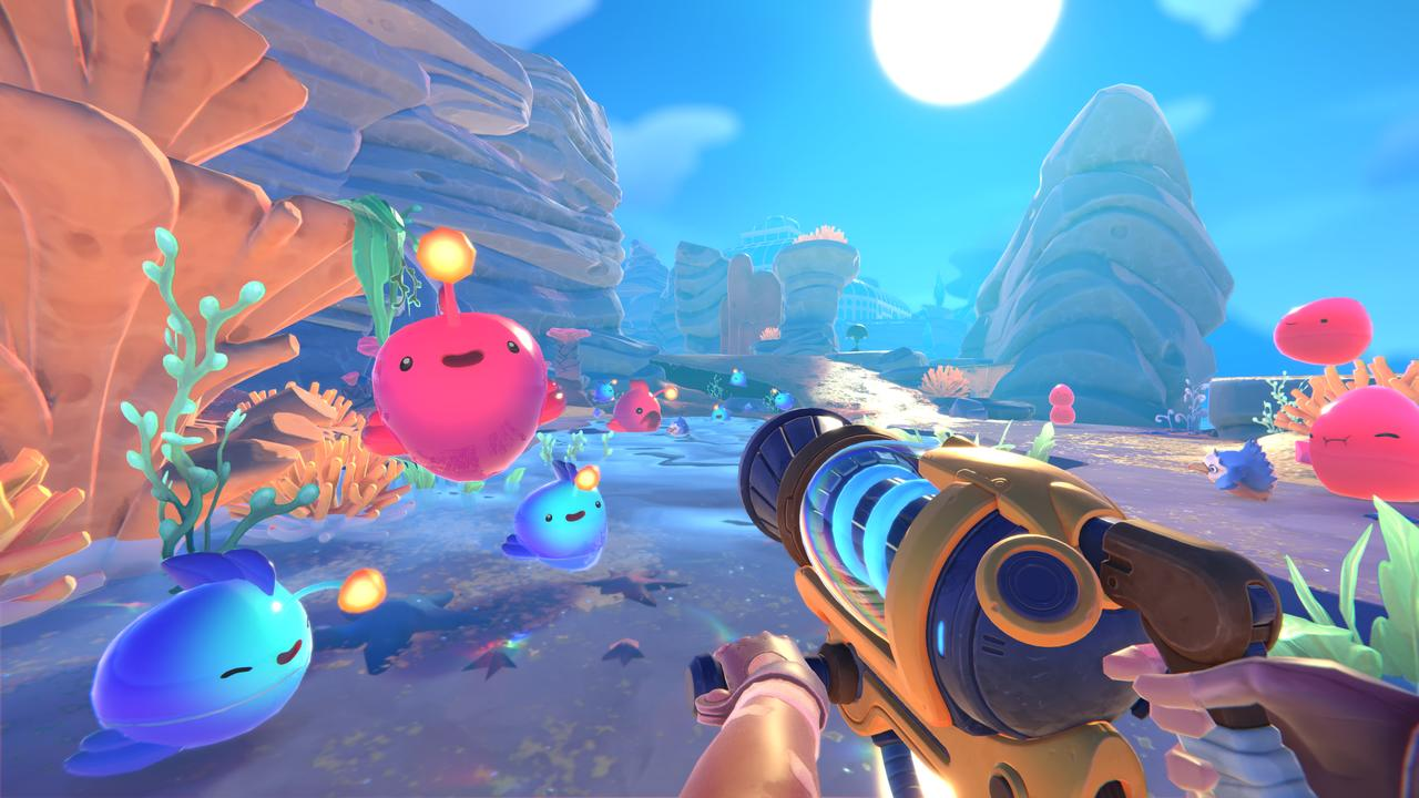 Ego-Perspektive einer Spielszene mit bunten Schleimen, einer Strahlenkanone und einem strahlend blauen Himmel.