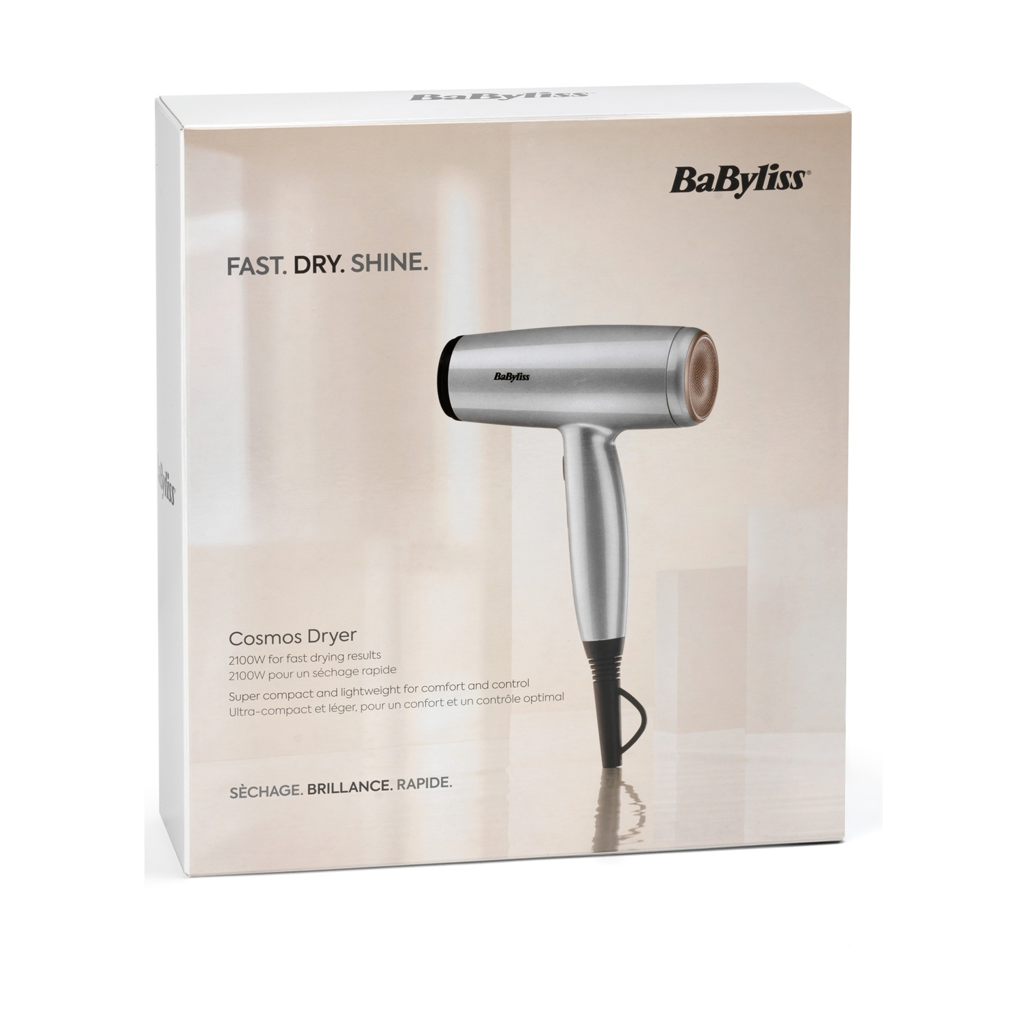 Una scatola di asciugacapelli Babyliss Cosmos. La scatola è bianca con un asciugacapelli argentato e marrone e le parole 'FAST. DRY. SHINE.' sono stampate.