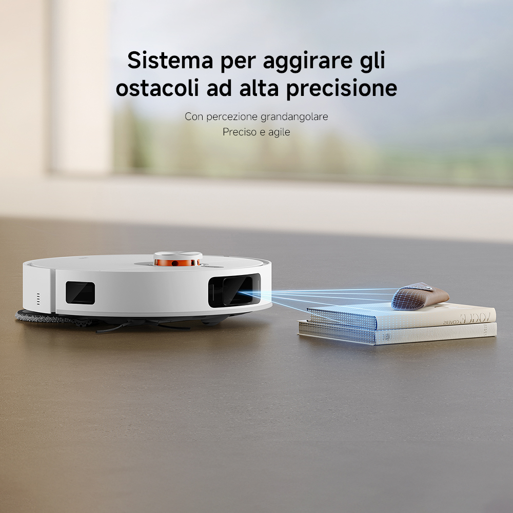 Un aspirapolvere robot bianco con tecnologia di evitamento degli ostacoli. Libri e un piccolo oggetto davanti.