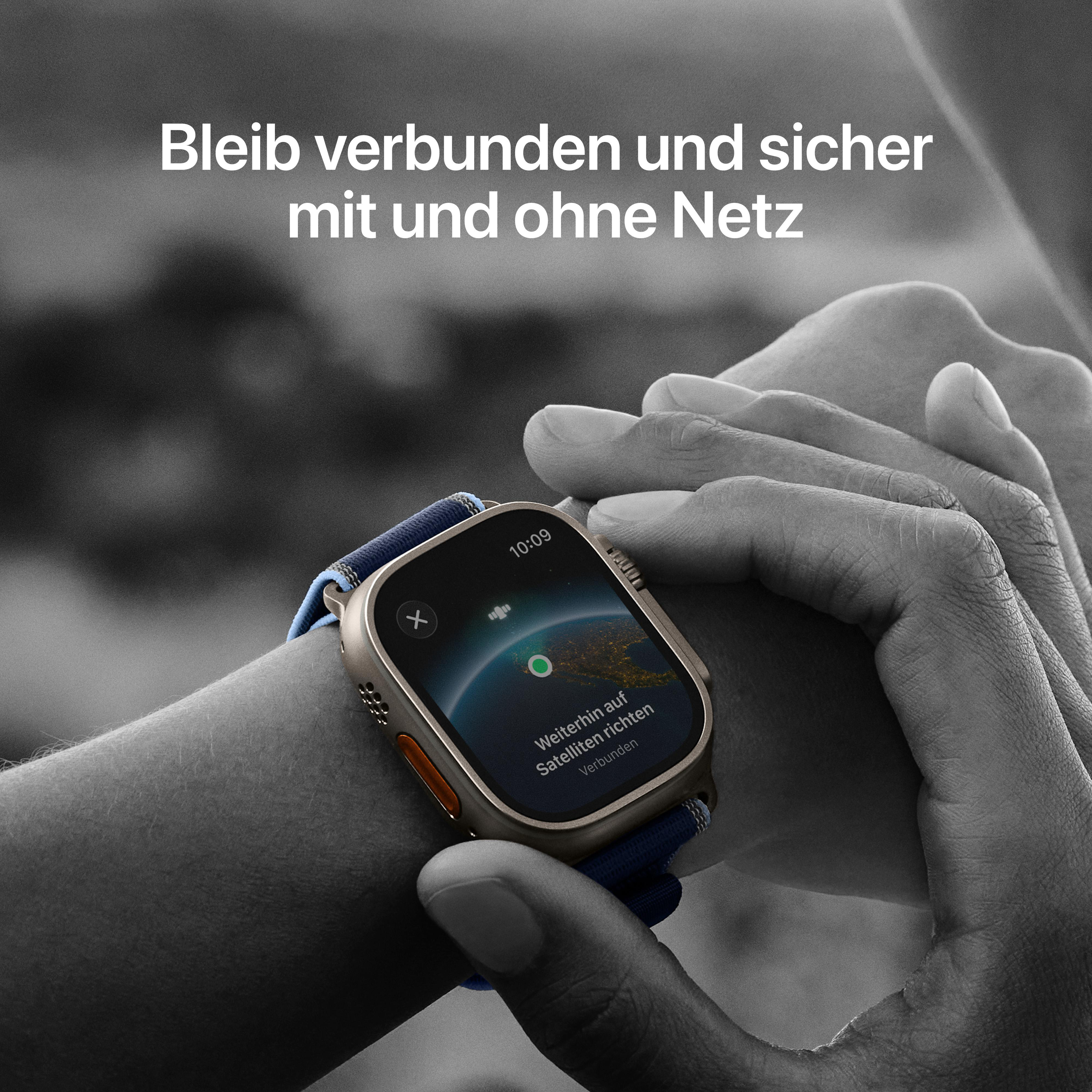 Eine Person trägt eine Smartwatch. Die Uhr zeigt einen Globus mit dem Text 'Verbunden via Satellit'.