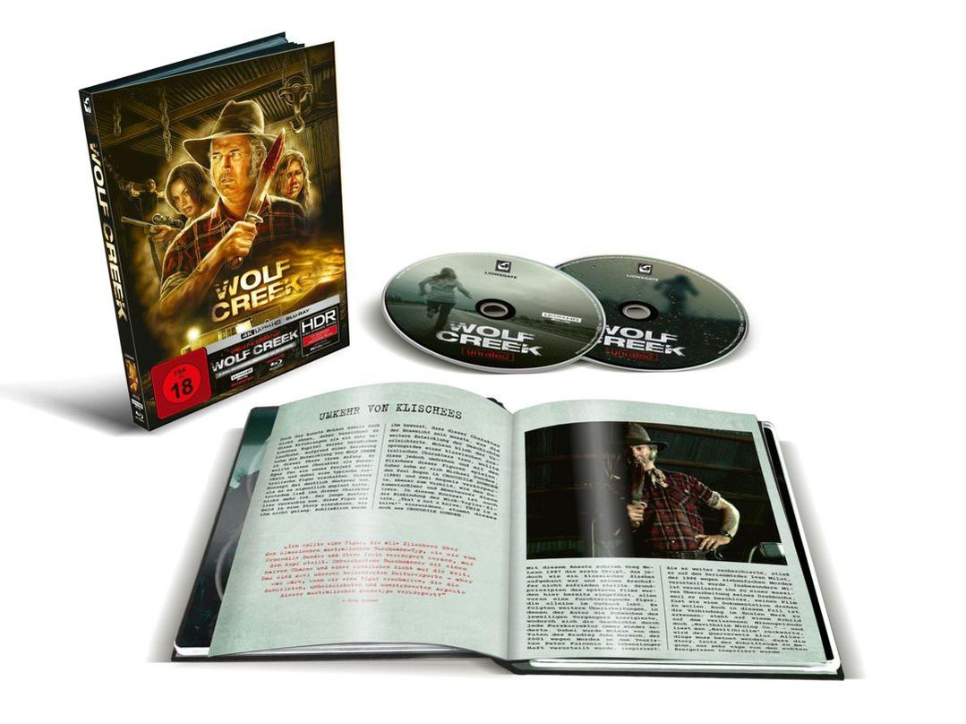 Wolf Creek Blu-ray-Set mit Discs, einem Buch und einer Filmbox. Die Box zeigt einen Mann mit einem Messer. Das Buch hat Text und ein Bild.