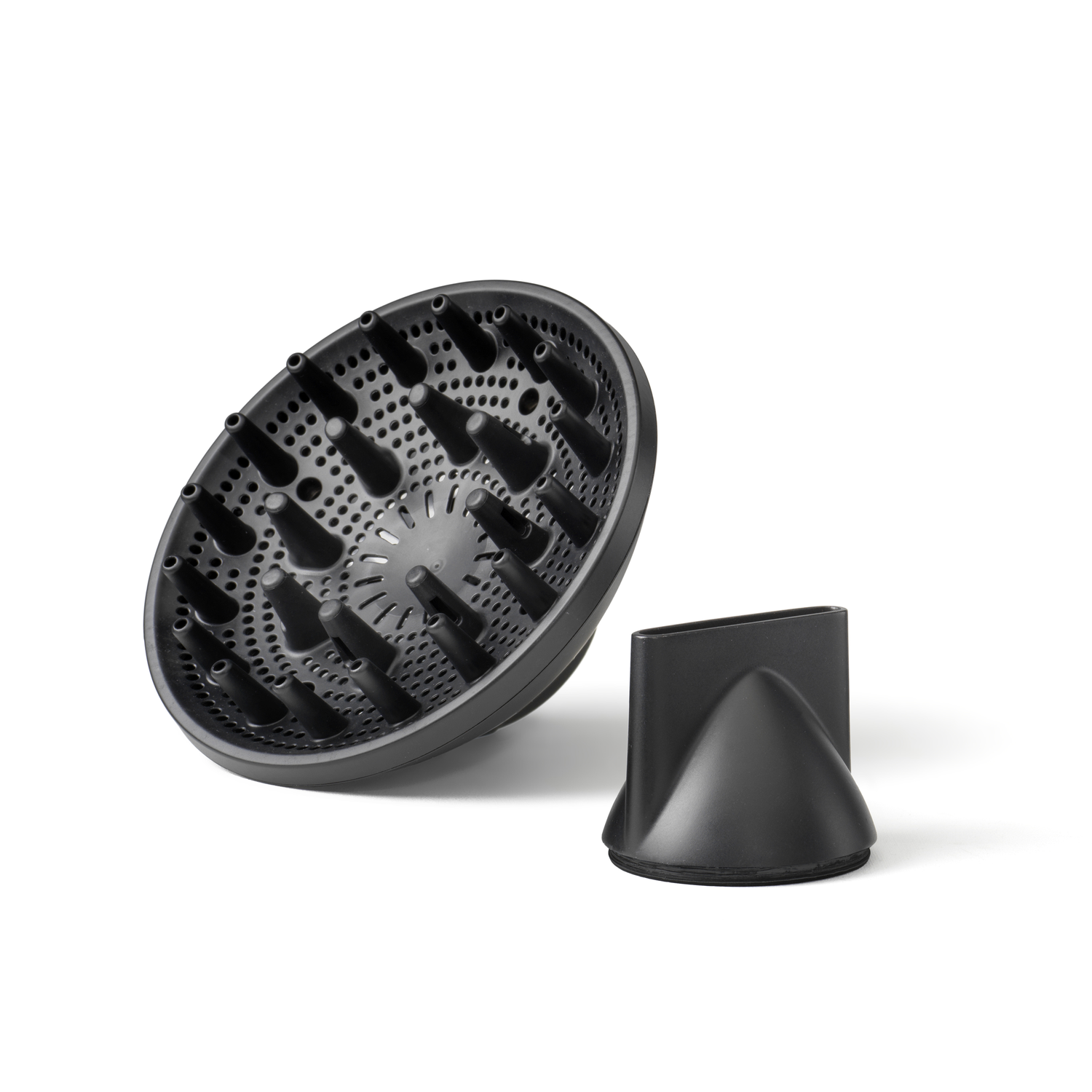 Black hair dryer diffuser and nozzle on white background. Diffuser has many holes and pegs. Nozzle is cone-shaped.