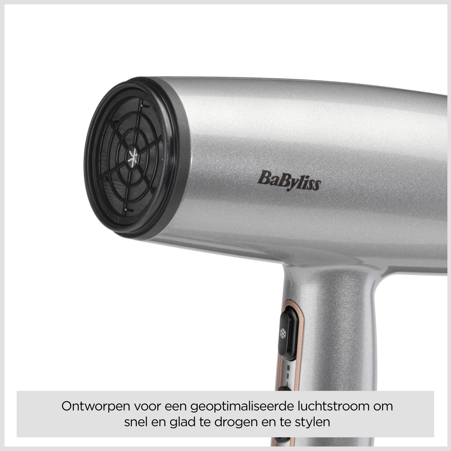 A silver Babyliss hairdryer is shown from an angle. The nozzle and handle are visible. Text at the bottom says it dries and styles hair.