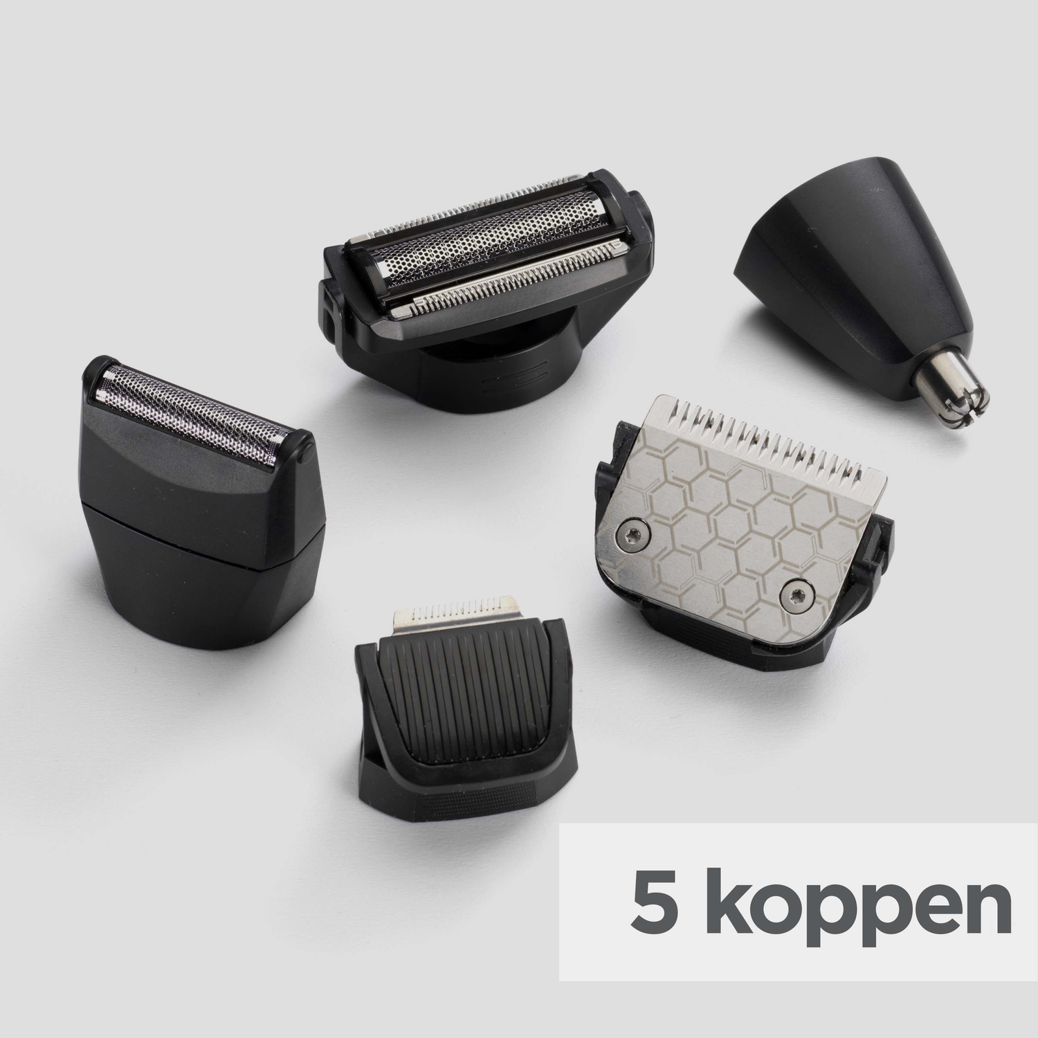 Five black and silver shaver heads on a white surface. One is for nose hair, the others are various clipper heads.