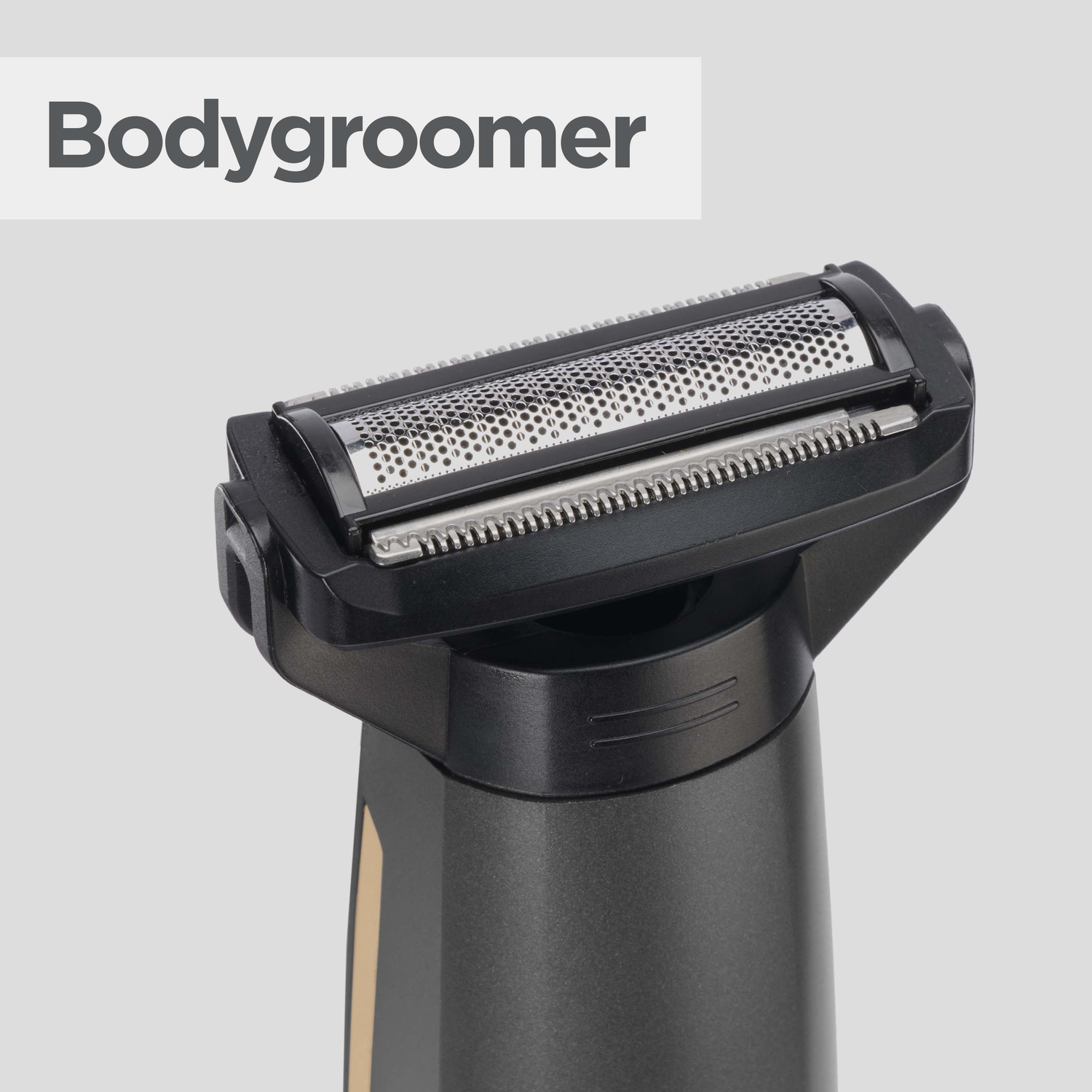 Close-up of a bodygroomer. The device is black and silver with a metal mesh blade. The background is light gray.