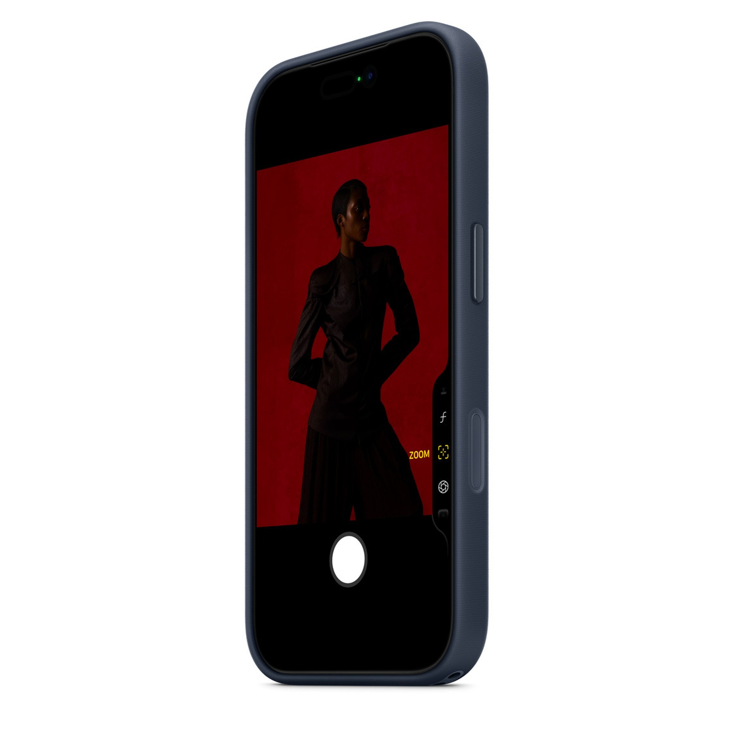 Un téléphone affiche une femme vêtue de sombre sur fond rouge. Le téléphone est dans une coque bleue, avec des contrôles de caméra.