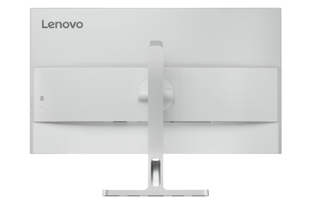 Parte trasera del monitor Lenovo blanco. Tiene soporte y puertos laterales. El logotipo está arriba. El fondo es negro.