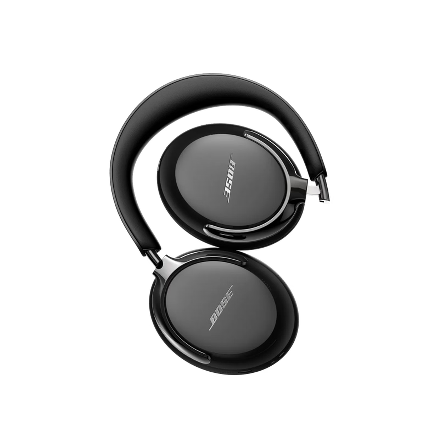 Casque Bose noir sur fond noir. Le casque est plié, montrant le logo Bose sur les écouteurs.