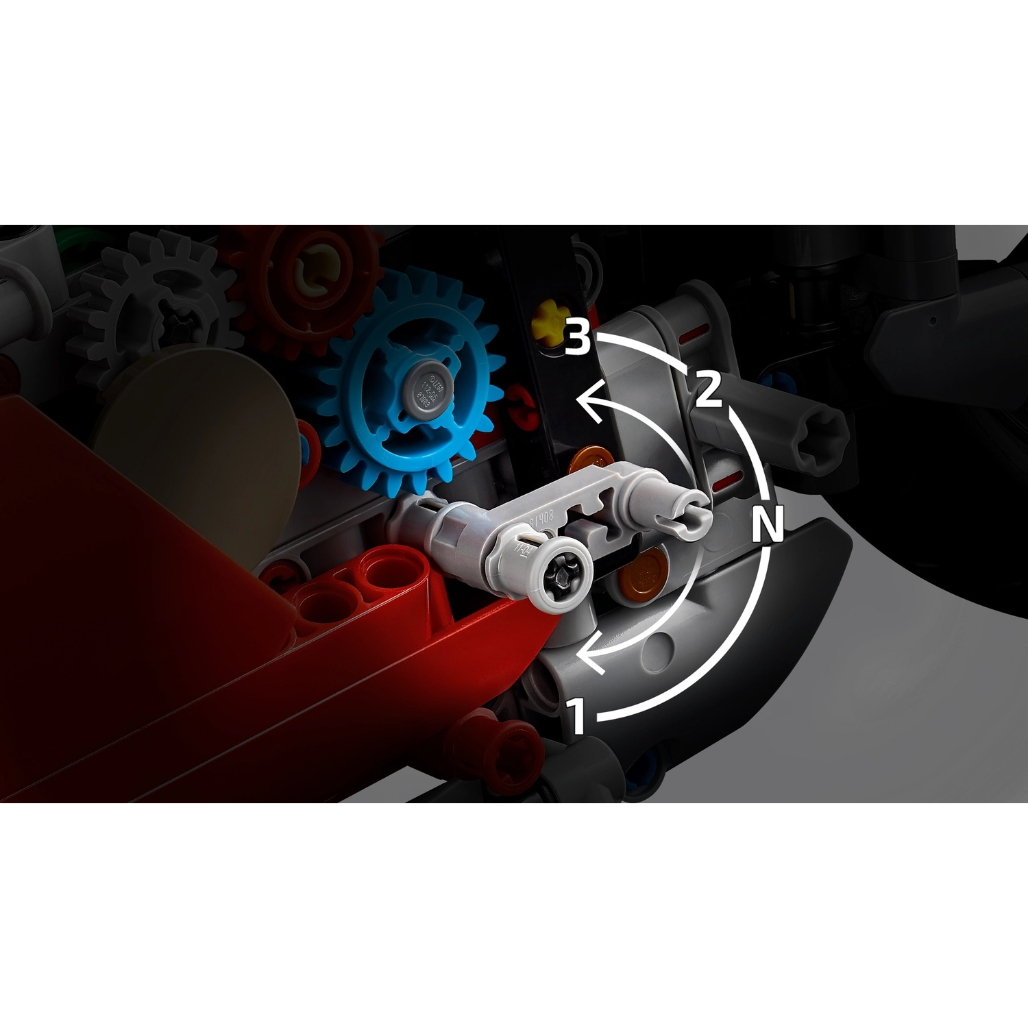 Primo piano del modello LEGO Technic. Sono visibili ingranaggi e leve. I numeri 1, 2 e 3 con frecce indicano le direzioni del movimento.