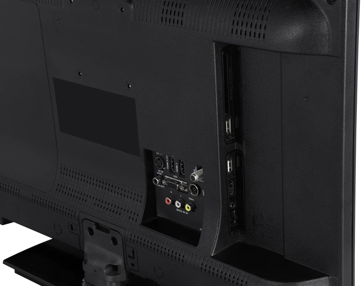 Tył czarnego telewizora z różnymi portami: HDMI, USB, VGA, wejścia audio i zasilanie. Obecny jest mały czarny prostokątny panel.
