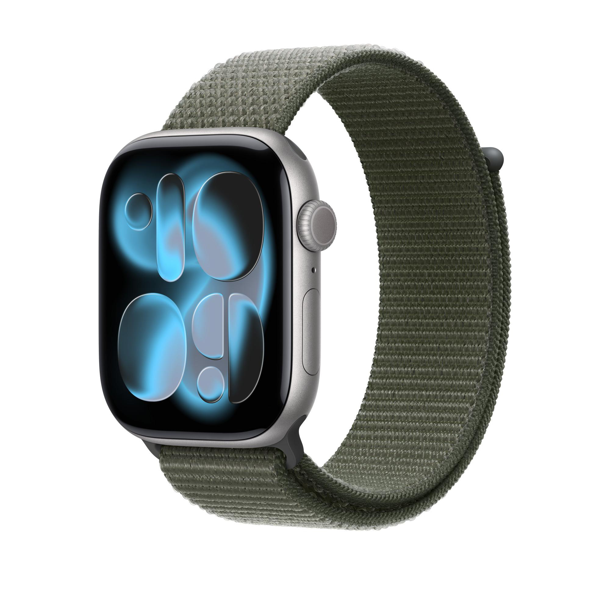 Apple Watch mit grünem Stoffband. Das Zifferblatt zeigt blaue Formen. Der Hintergrund ist weiß.