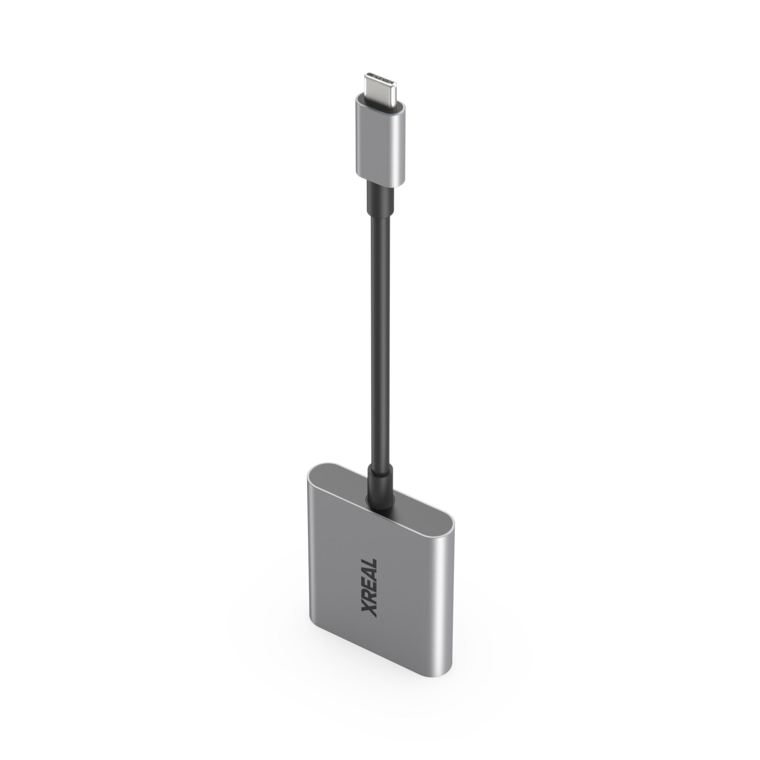 Ein silberner USB-C-Adapter mit einem schwarzen Kabel. Auf dem Adapter steht 'XREAL'.