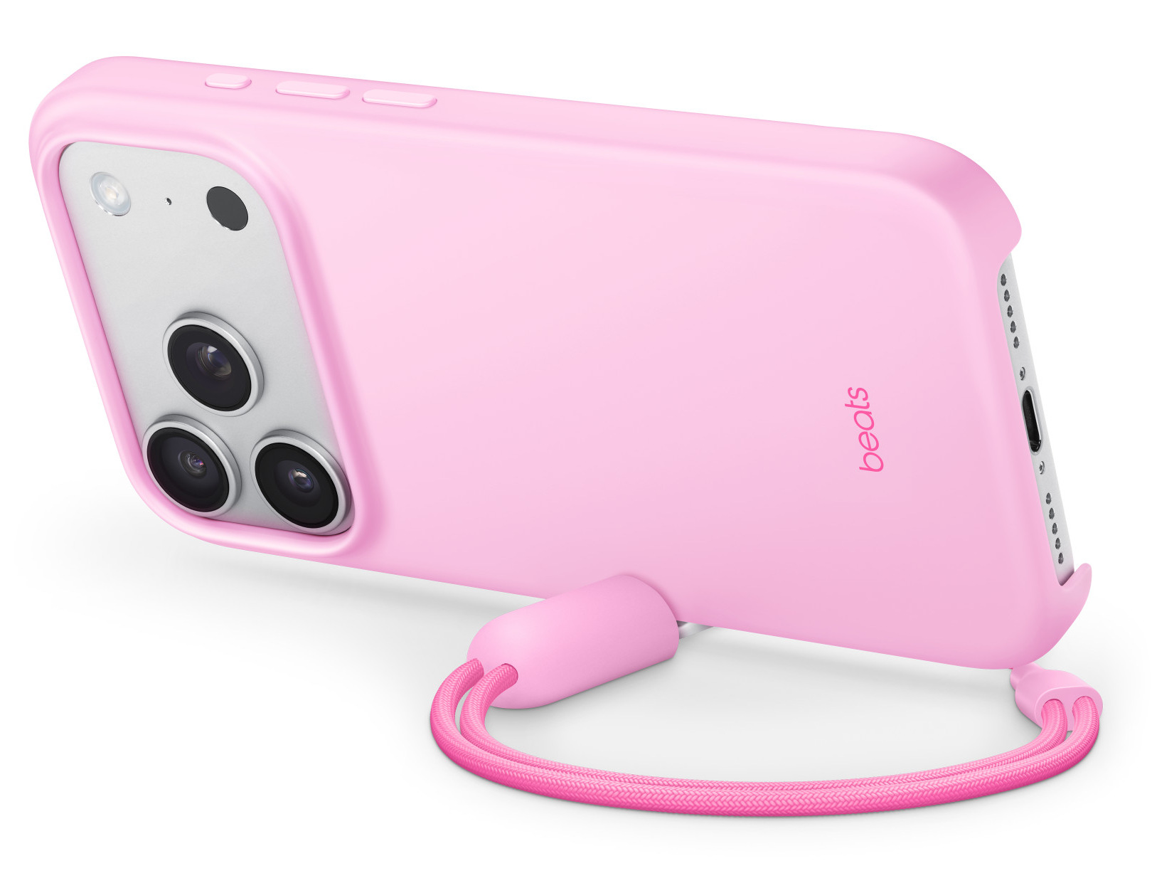 Różowe etui na telefon z paskiem. Etui ma moduł aparatu z trzema soczewkami i napisem 'beats'.