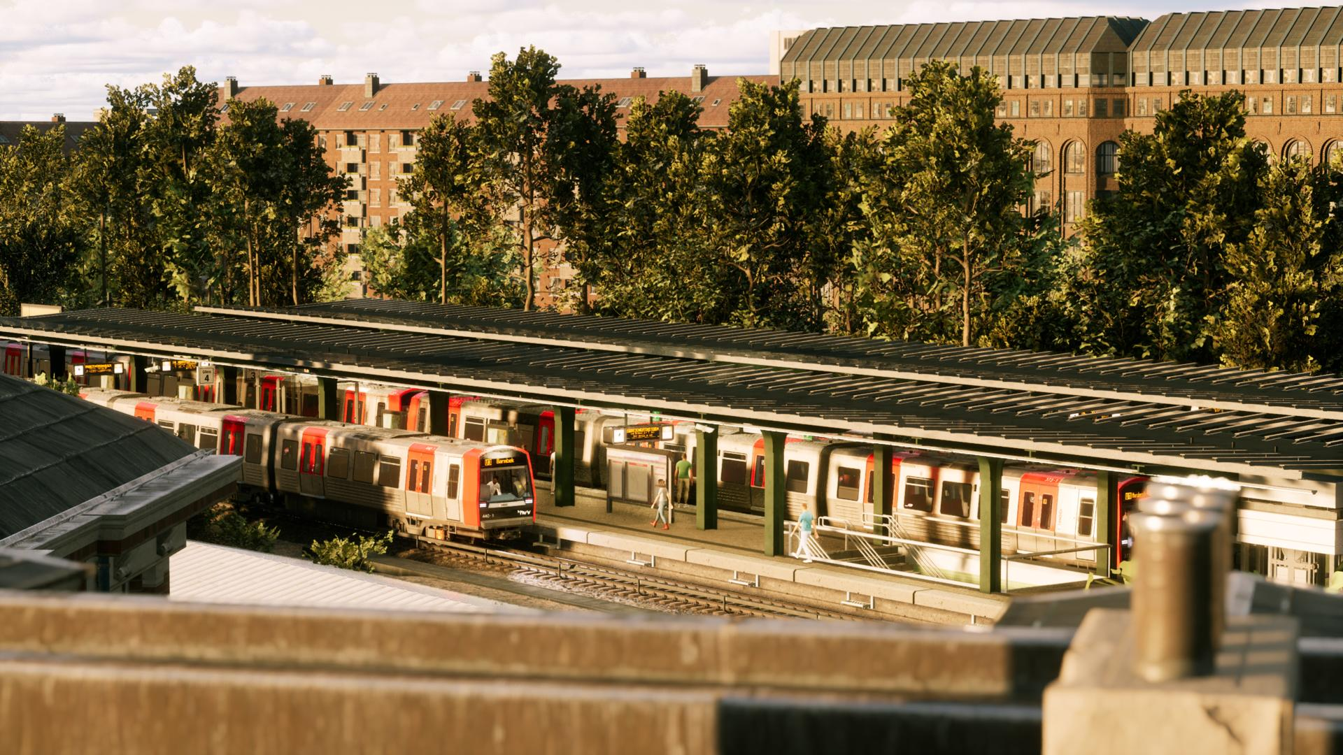 Ein Bahnhof mit Zügen auf dem Bahnsteig. Gebäude und Bäume im Hintergrund.