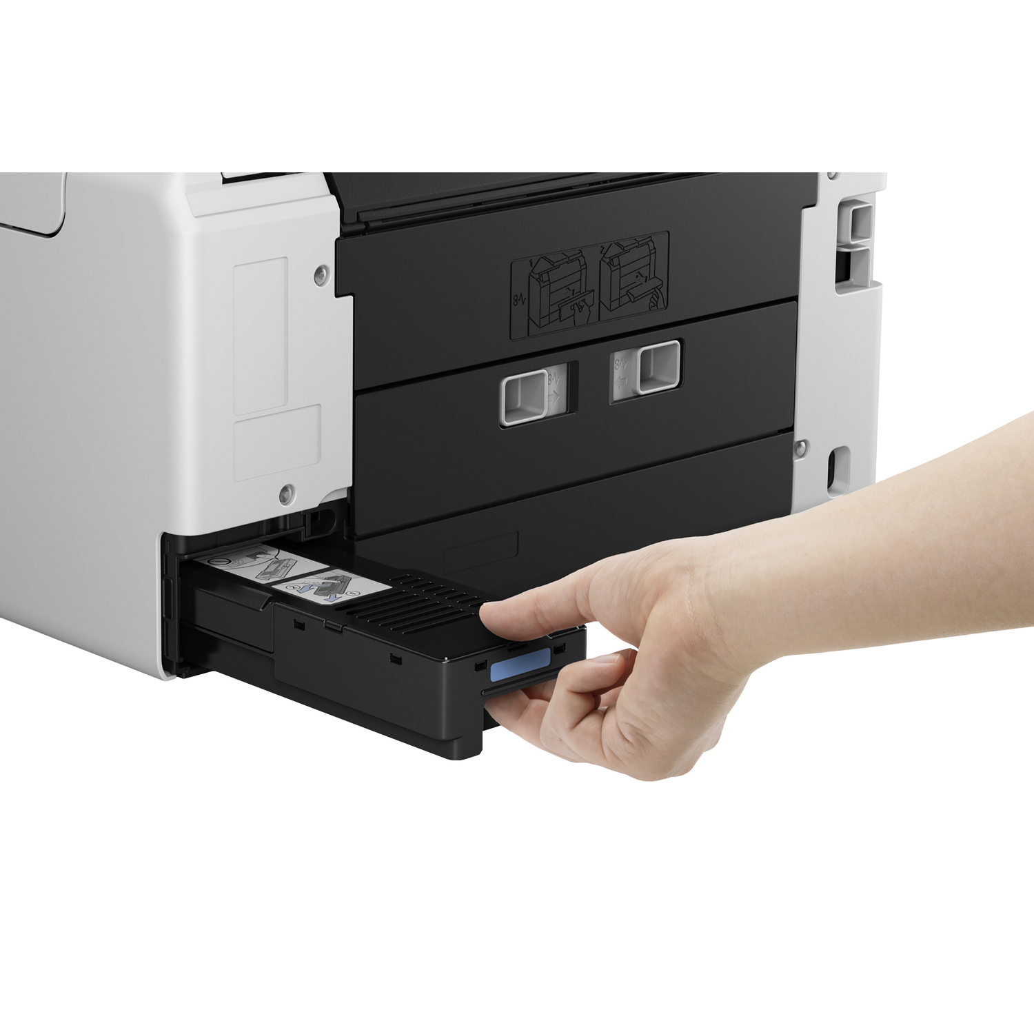 A hand pulls a black printer tray from a white and black printer. The tray contains printed sheets.