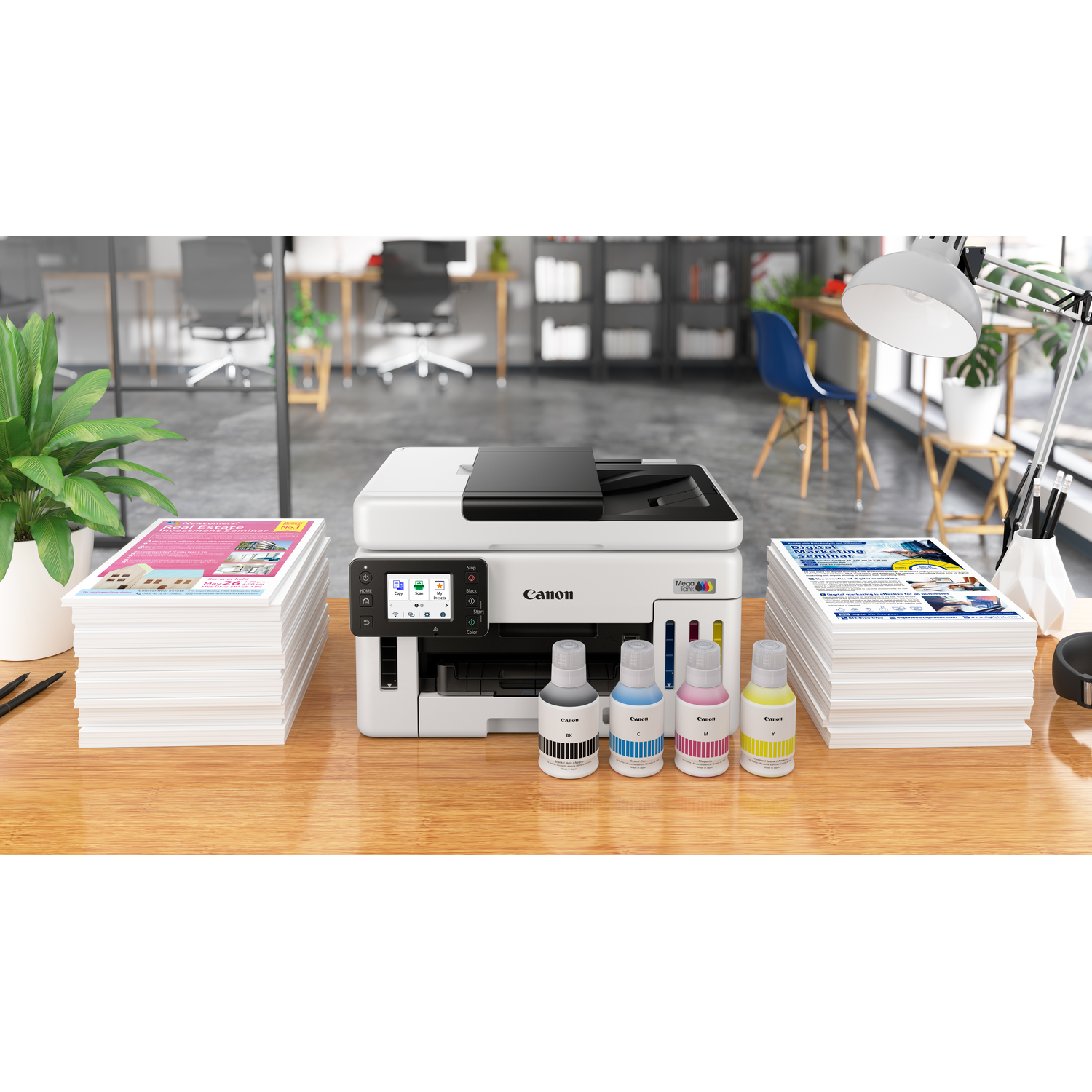 A Canon printer on a wooden desk, with ink bottles, stacks of paper, and a desk lamp. The background shows an office.