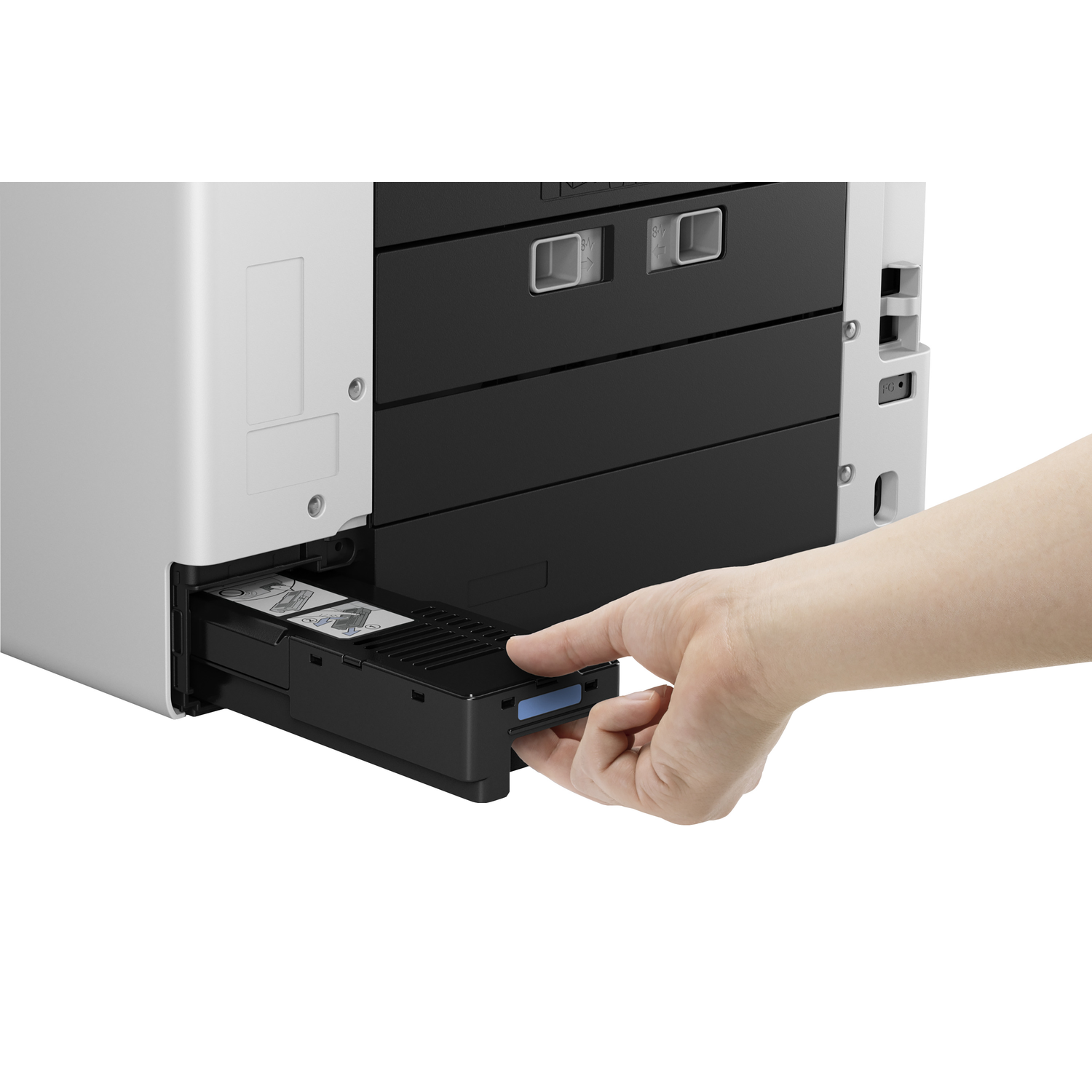 A hand pulls out a black printer tray. The printer is white and black. The tray contains paper. The background is white.