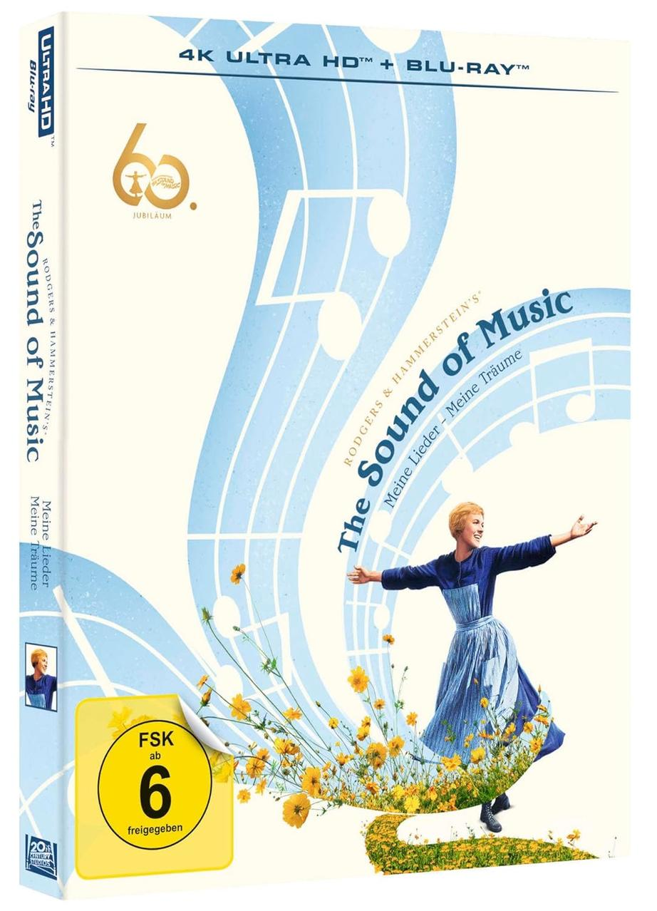 Die Sound of Music Blu-ray-Hülle. Julie Andrews in blauem Kleid, Arme ausgestreckt, mit Noten und Blumen.