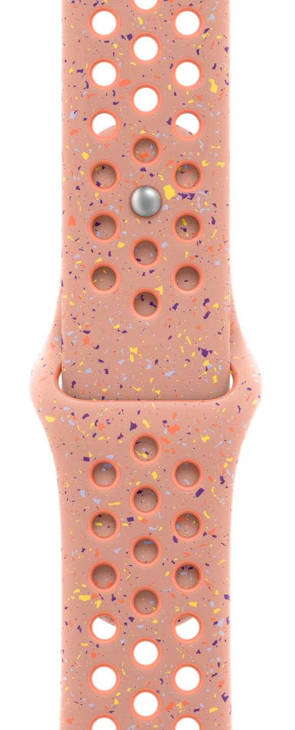 Bransoleta do zegarka w kolorze brzoskwiniowym z nakrapianym wzorem. Zawiera wiele otworów. Posiada srebrne zapięcie. Tło jest czarne.