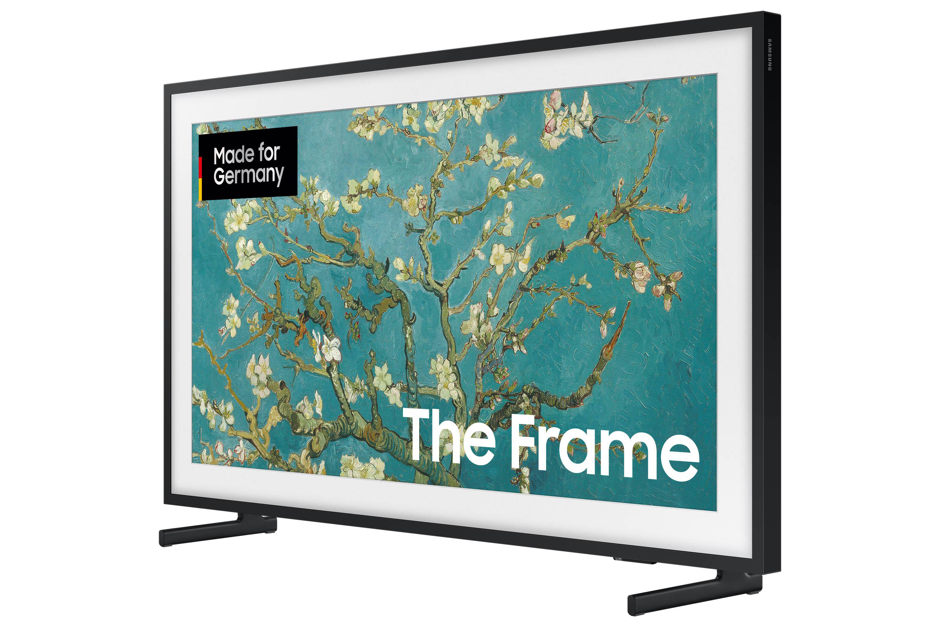 Ein schwarz gerahmter Samsung-Fernseher zeigt ein Gemälde mit weißen Blumen auf türkisem Grund mit dem Text 'The Frame'.