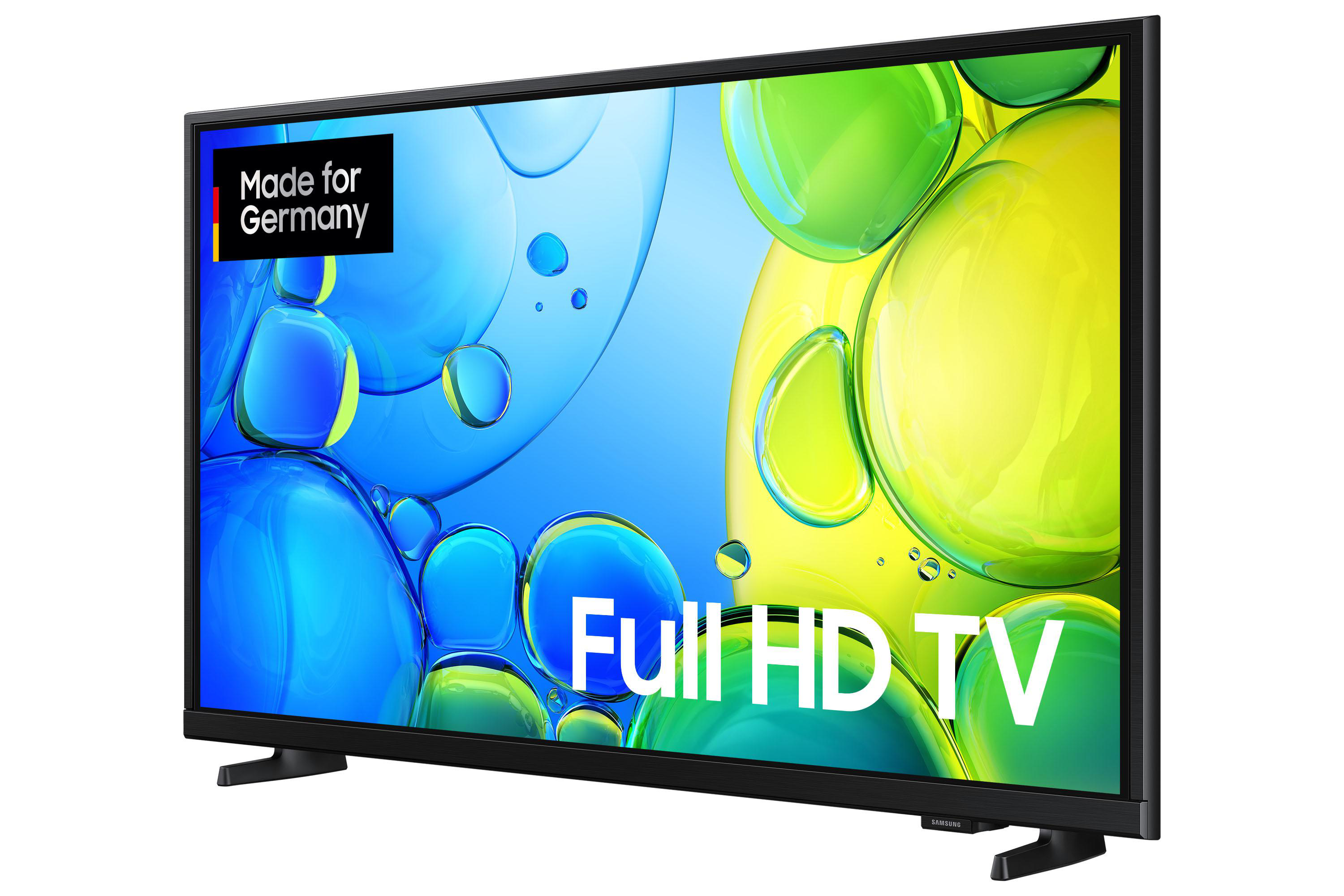 Ein Full-HD-Fernseher mit schwarzem Rahmen. Der Bildschirm zeigt ein farbenfrohes, abstraktes Muster. Text: Made for Germany, Full HD TV.