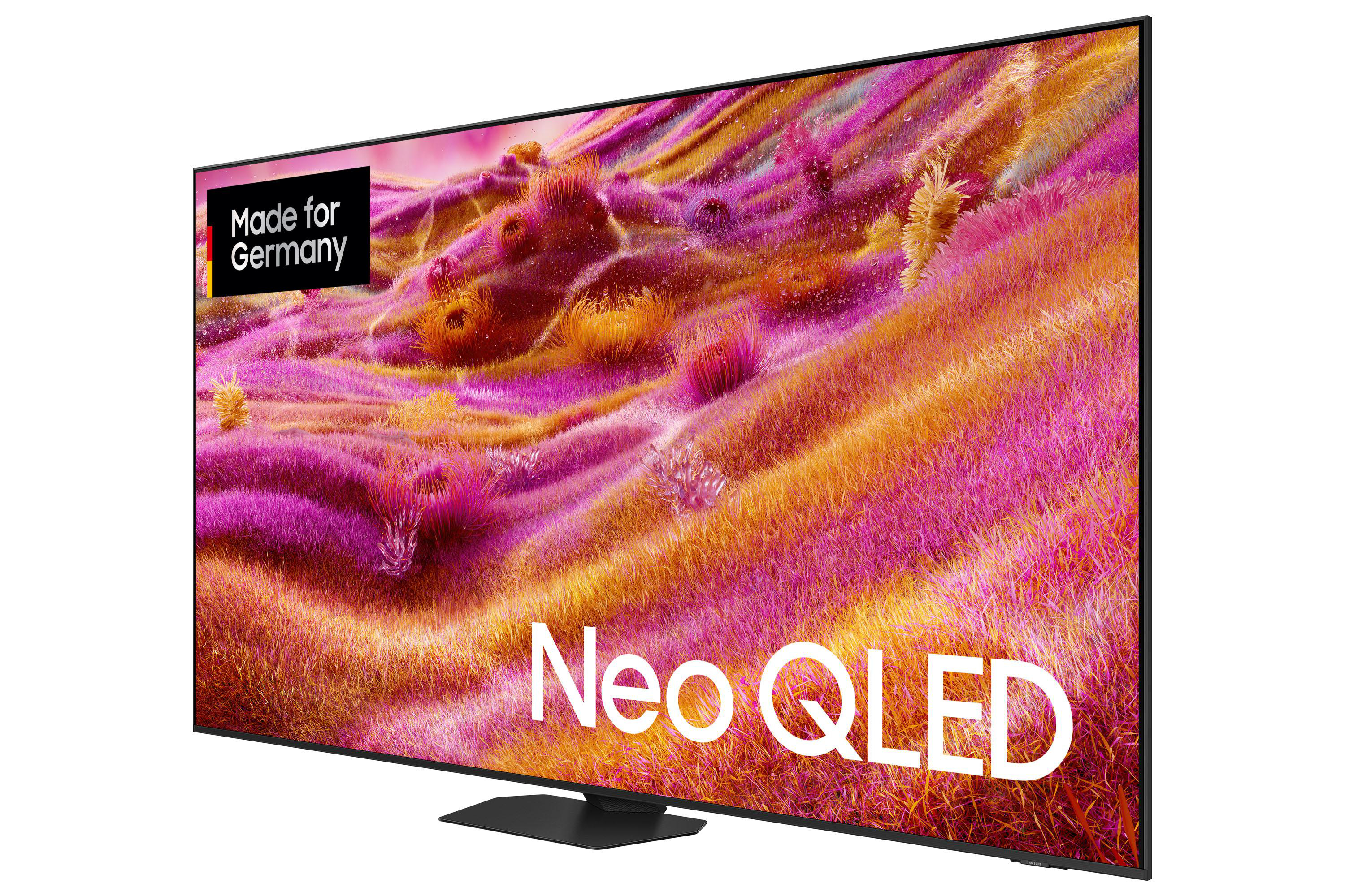 Ein Fernseher zeigt eine farbenfrohe Landschaft. Der Fernseher hat einen schwarzen Rahmen und Standfuß. Text 'Neo QLED' ist auf dem Bildschirm.