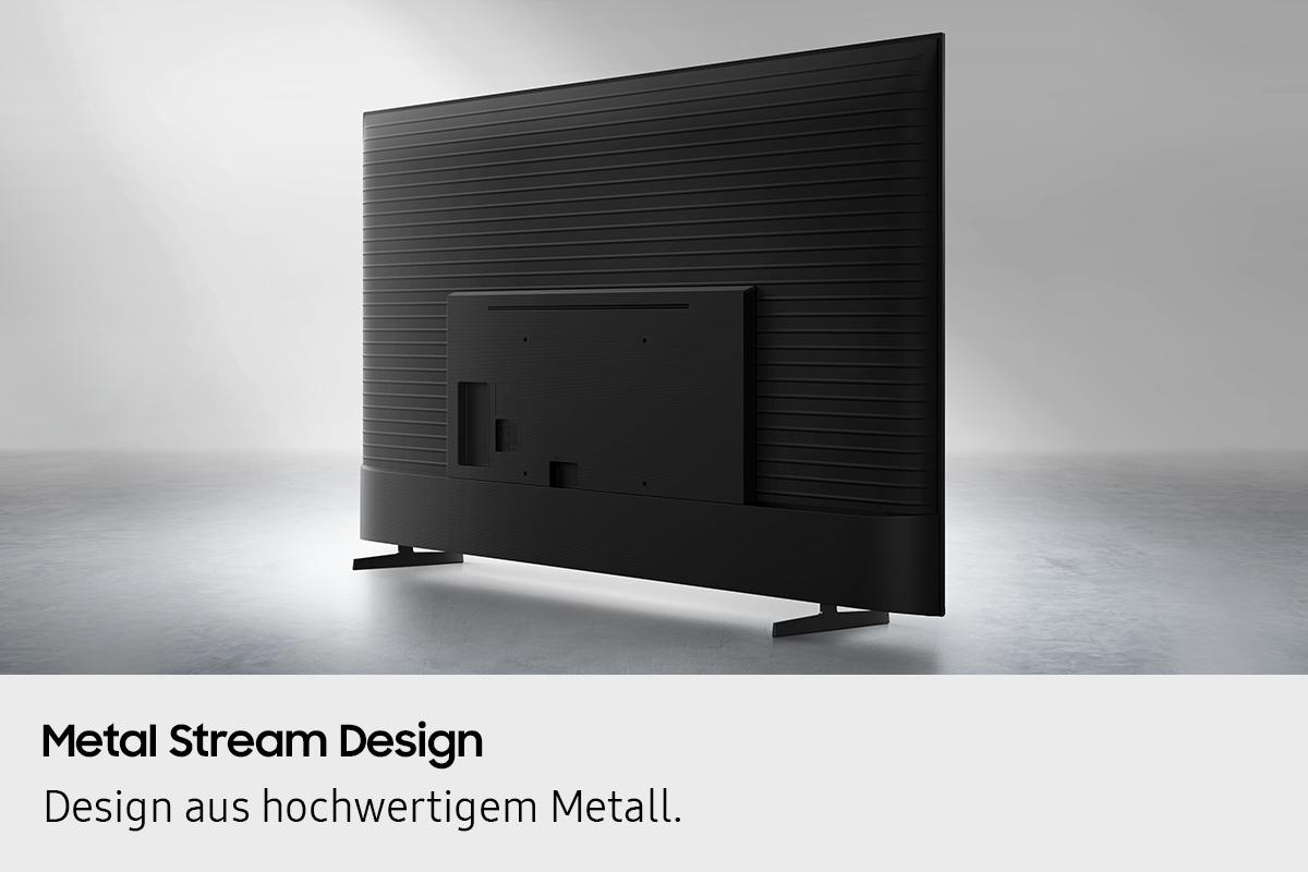 Rückansicht eines schwarzen Fernsehers mit Metal Stream Design. Der Fernseher hat eine rechteckige Form und steht auf grauem Untergrund.