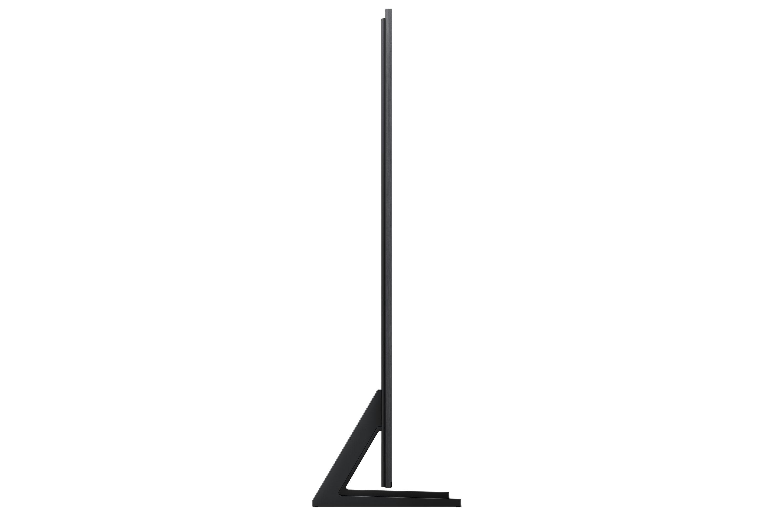 Ein hoher, schlanker schwarzer Fernseher im Profil vor weißem Hintergrund. Sockel und Ständer sind ebenfalls schwarz.