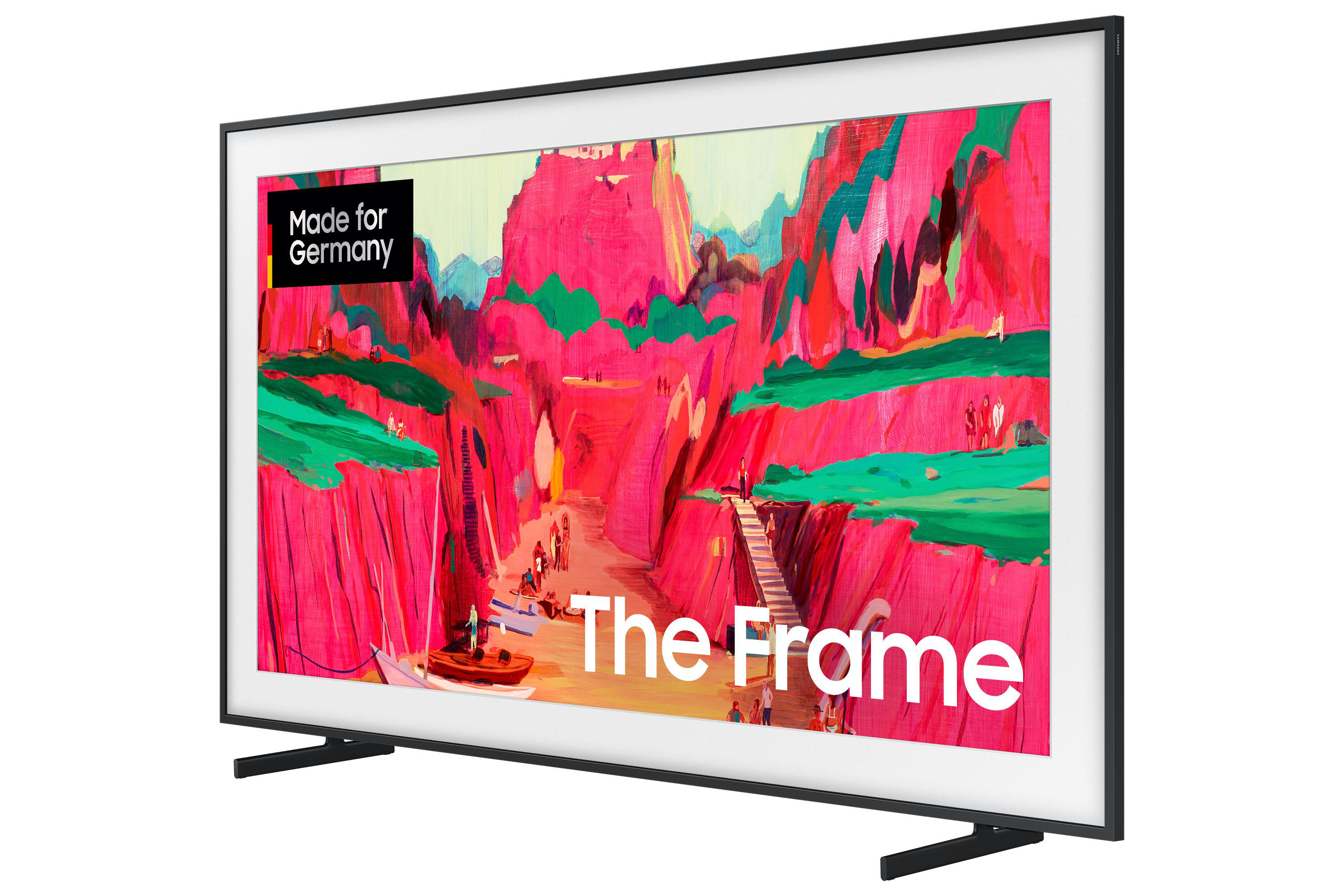 Ein schwarz gerahmter Fernseher zeigt farbenfrohe Landschaftskunst mit dem Text 'Made for Germany' und 'The Frame'.