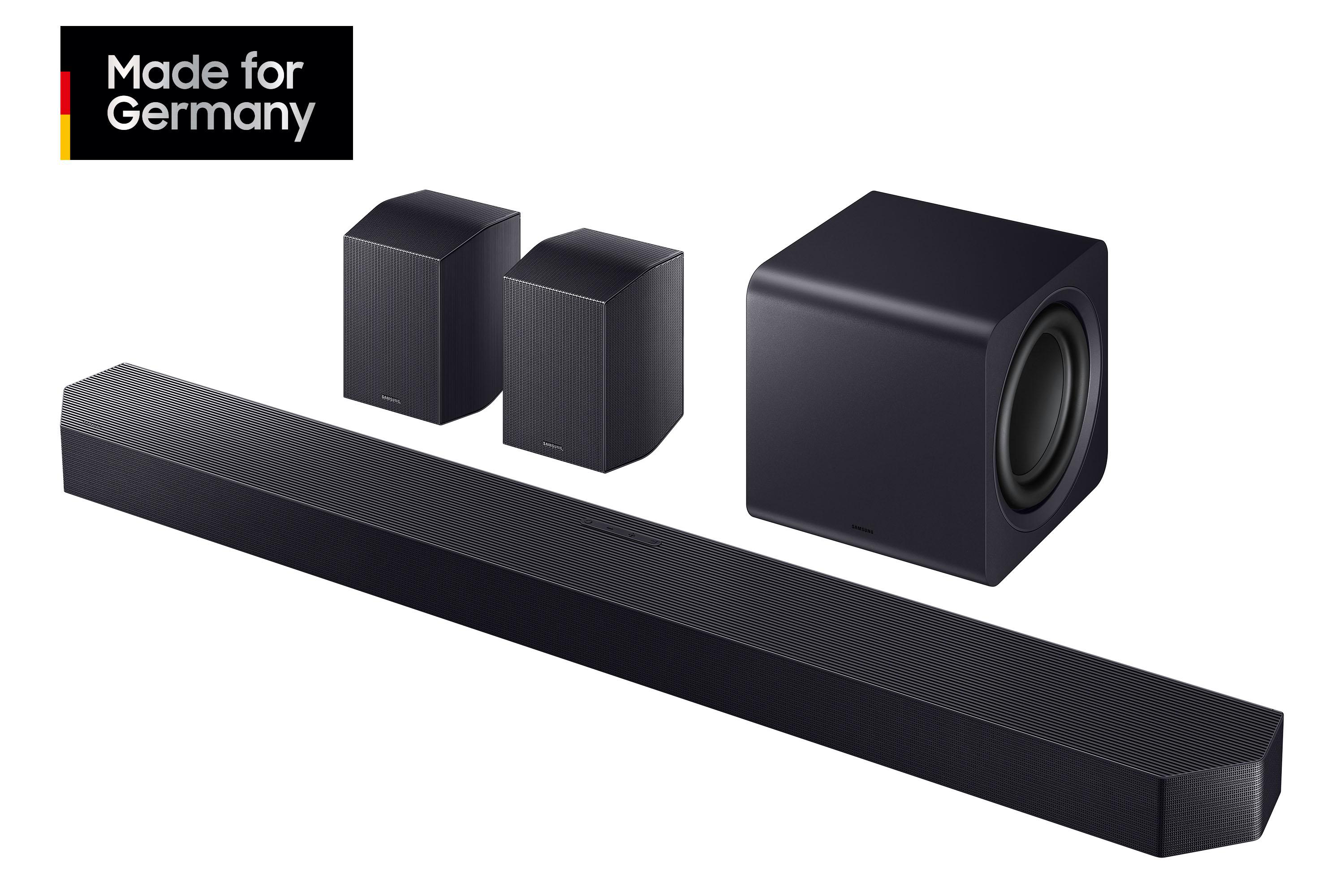 Eine schwarze Soundbar, zwei Lautsprecher und ein Subwoofer. Die Soundbar ist lang, die Lautsprecher quaderförmig, der Subwoofer ein Würfel.