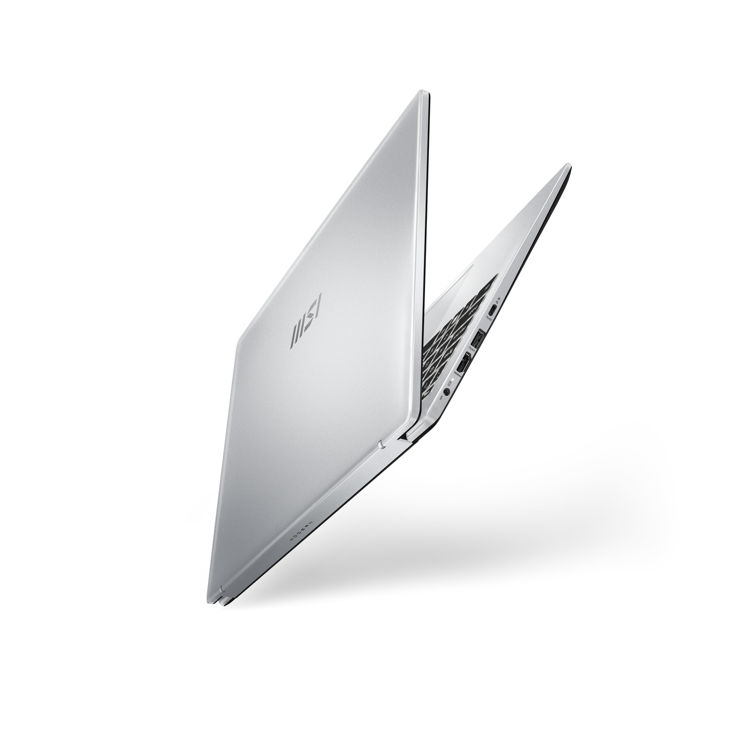 A silver laptop is slightly open. The MSI logo is visible on the lid. Keyboard and ports are visible. White background.