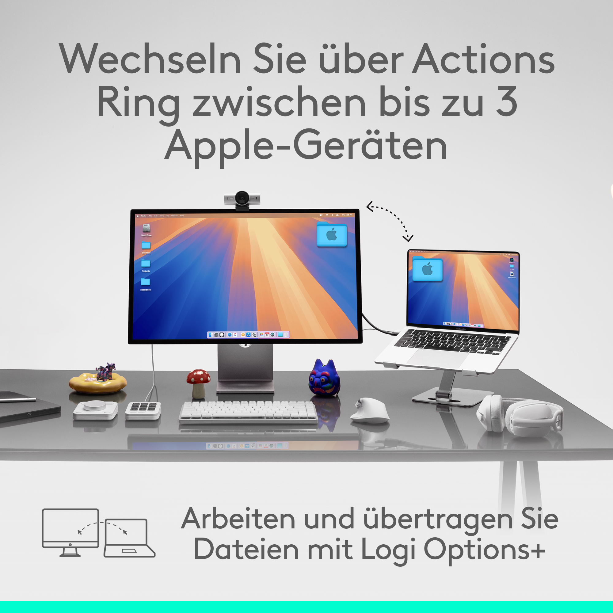 Ein Schreibtisch mit Monitor, Laptop und Zubehör. Text auf Deutsch sagt, zwischen Apple-Geräten wechseln.