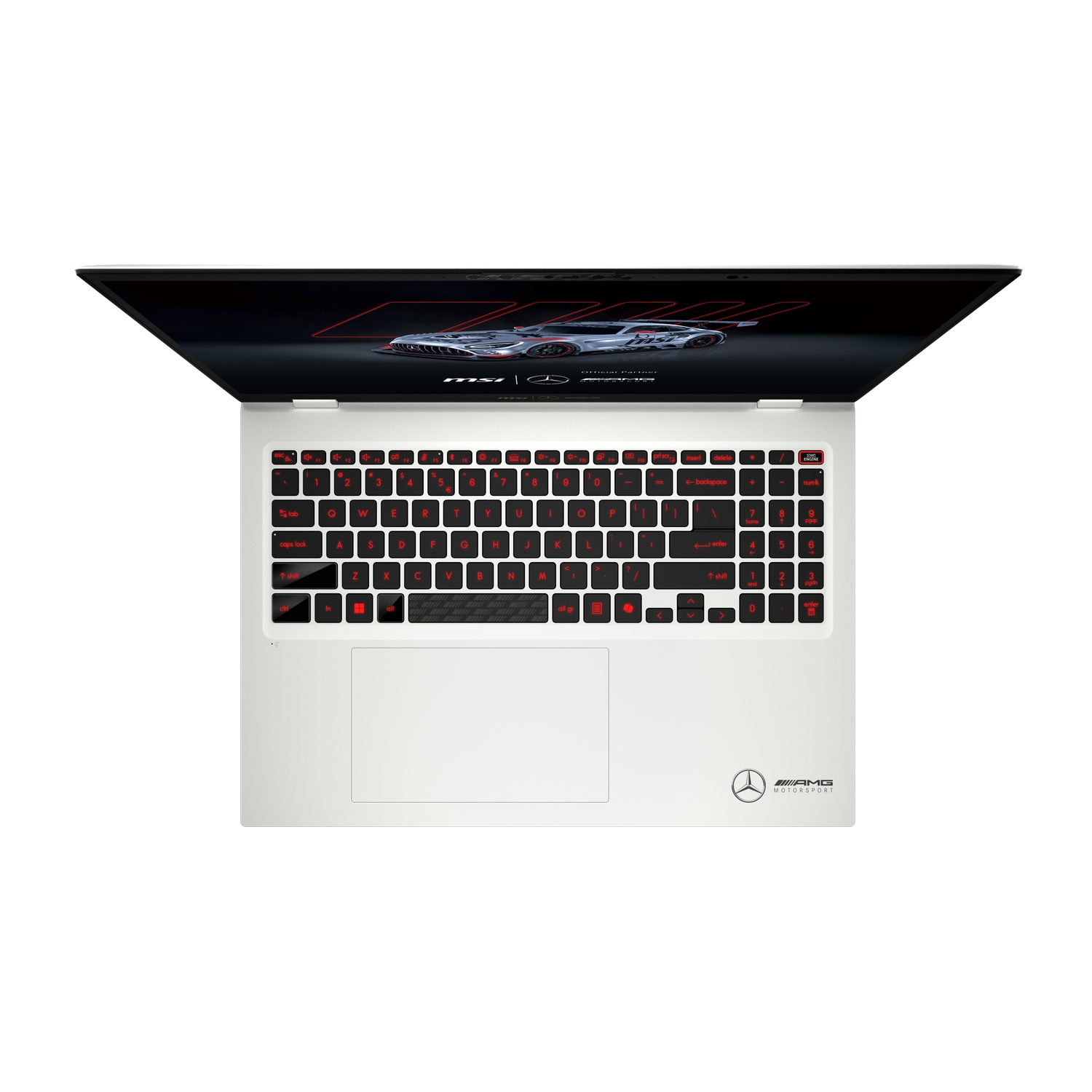 A white laptop with a red backlit keyboard is open. The screen shows a race car design. An AMG logo is visible.
