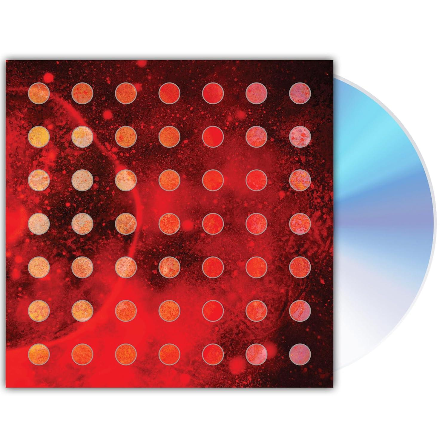 CD-Hülle mit rotem Hintergrund, orangefarbenen Kreisen und CD. Das Cover hat ein Muster aus orangefarbenen Kreisen auf rotem Hintergrund.