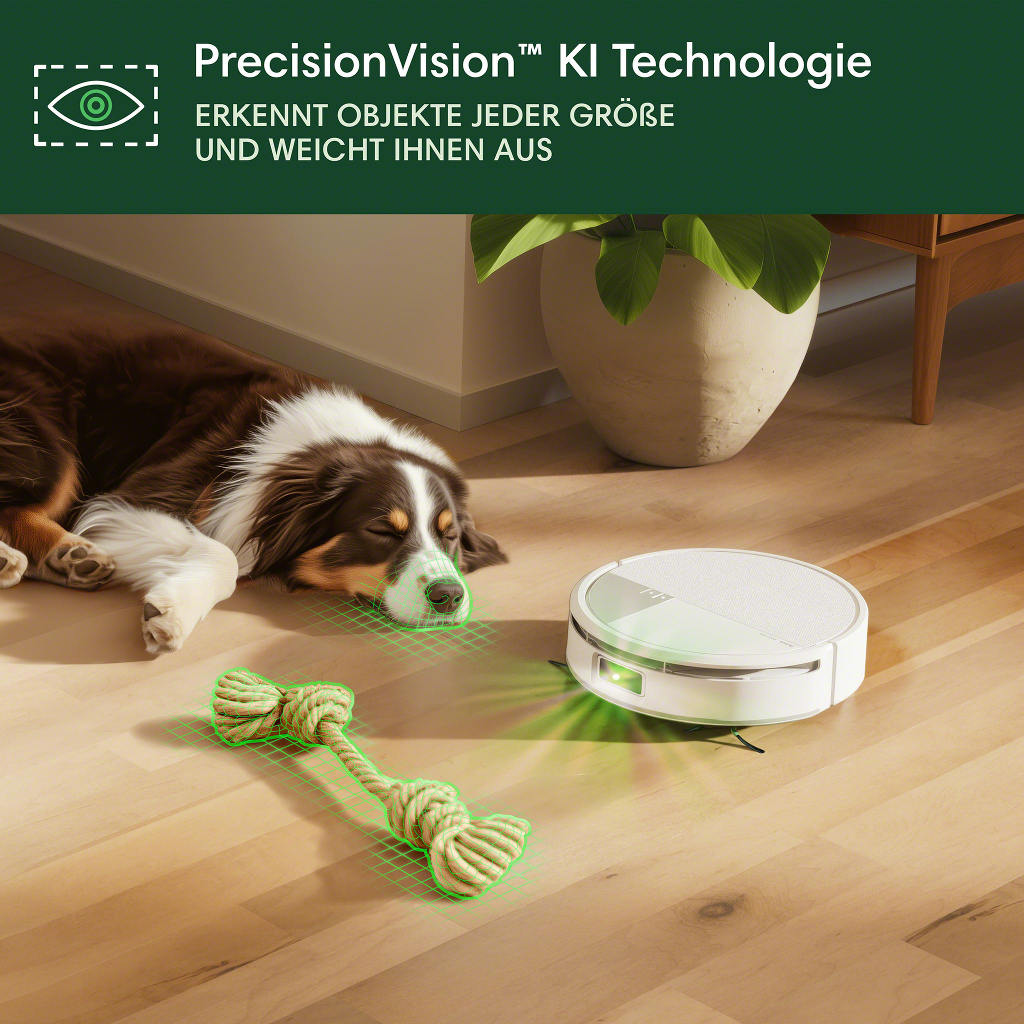 Ein Hund liegt in der Nähe eines Roboterstaubsaugers und eines Seilspielzeugs. Der Staubsauger hat ein grünes Licht.