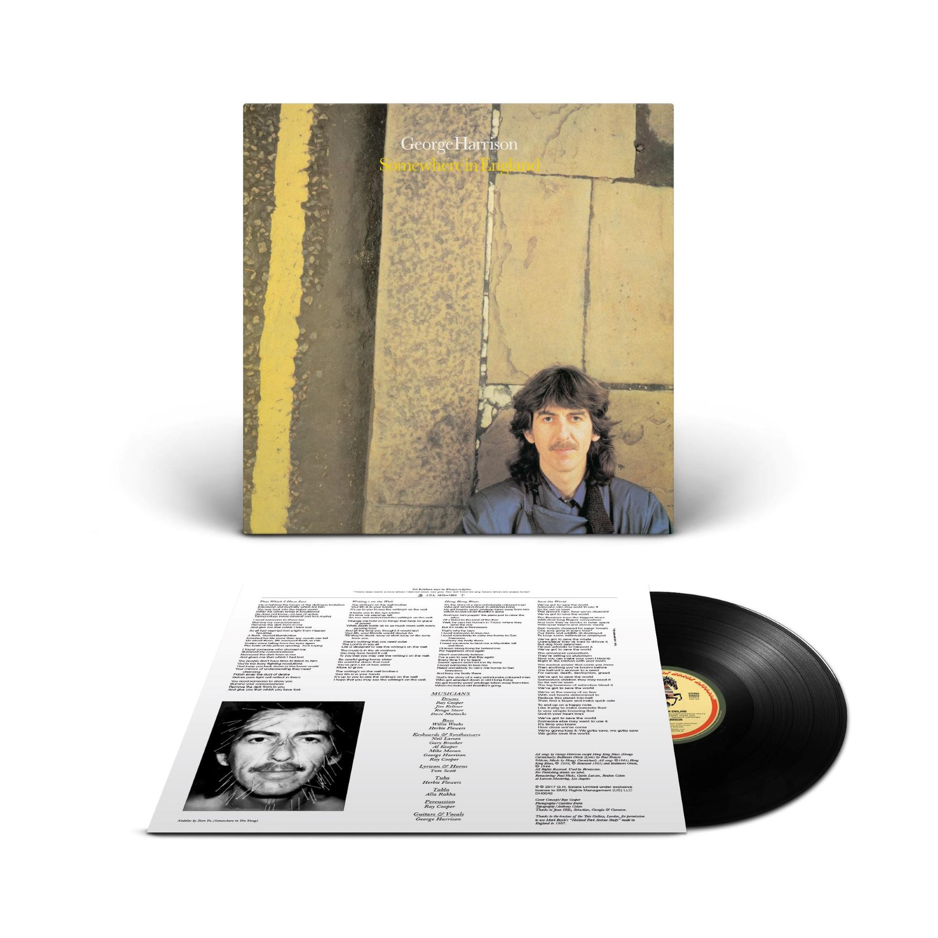 Albumcover von George Harrison, mit gelbem Streifen und Text. Eine Schallplatte und ein Textblatt sind ebenfalls sichtbar.