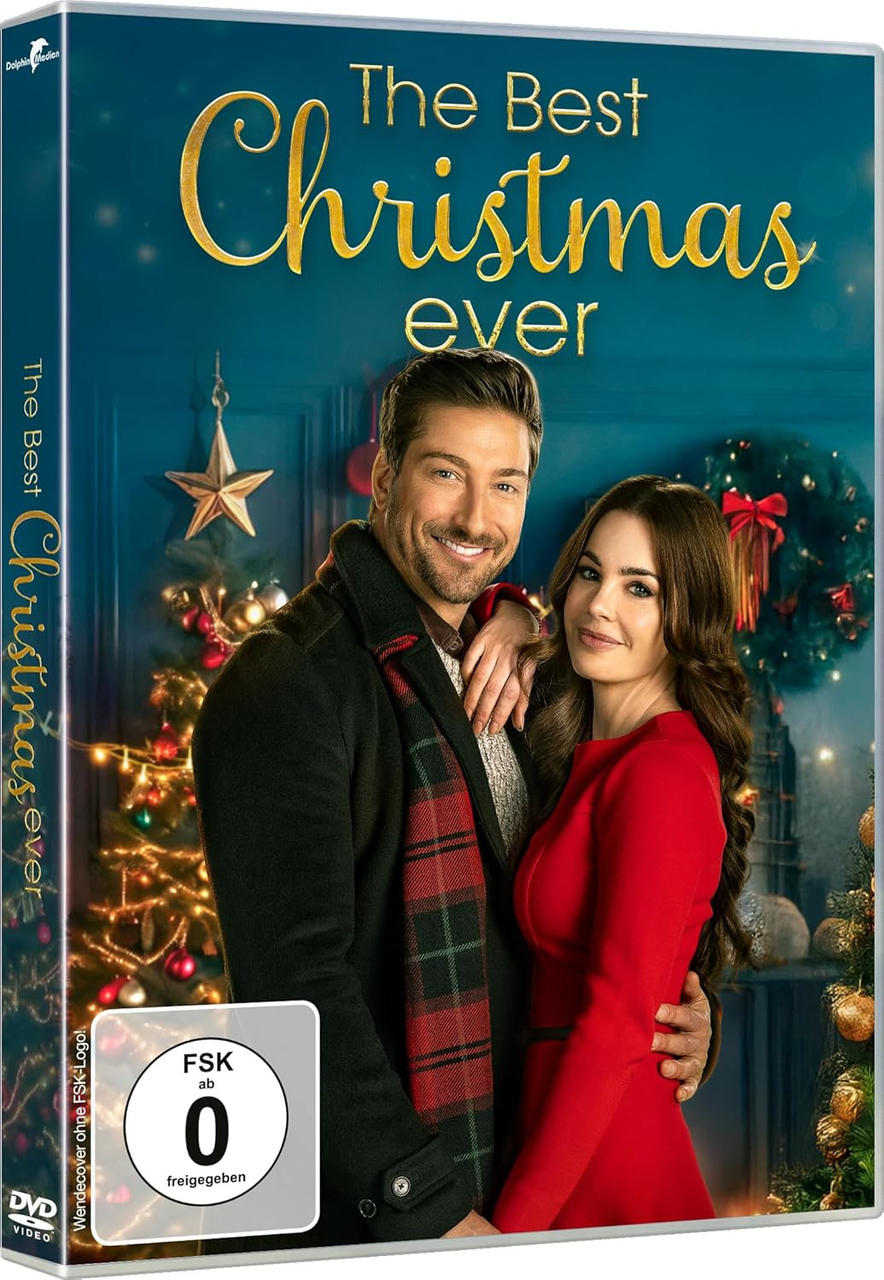 DVD-Cover: Ein lächelndes Paar vor einem Weihnachtsbaum. Text: The Best Christmas Ever. Ein Mann in einem Mantel und eine Frau in einem roten Kleid.