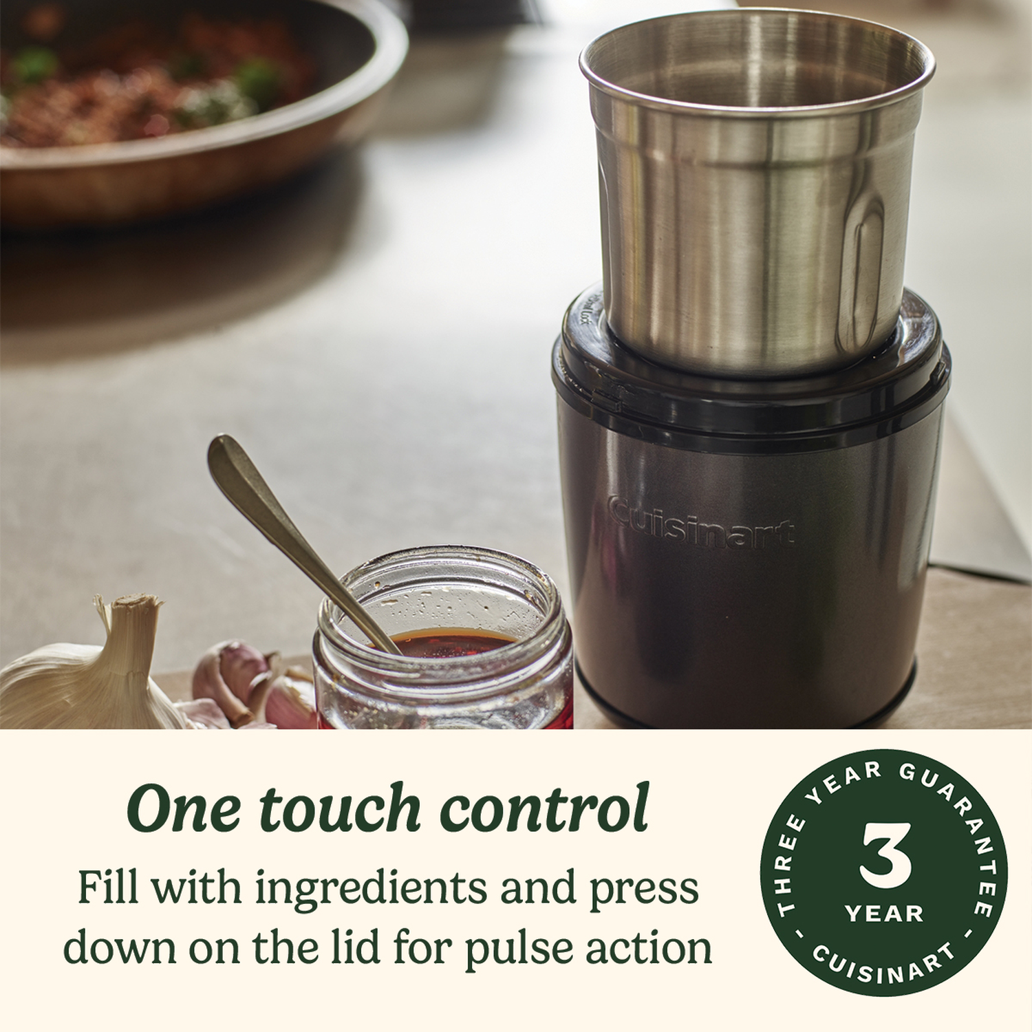A Cuisinart food processor with ingredients, garlic, and a jar of oil. Text reads, 'One touch control'.