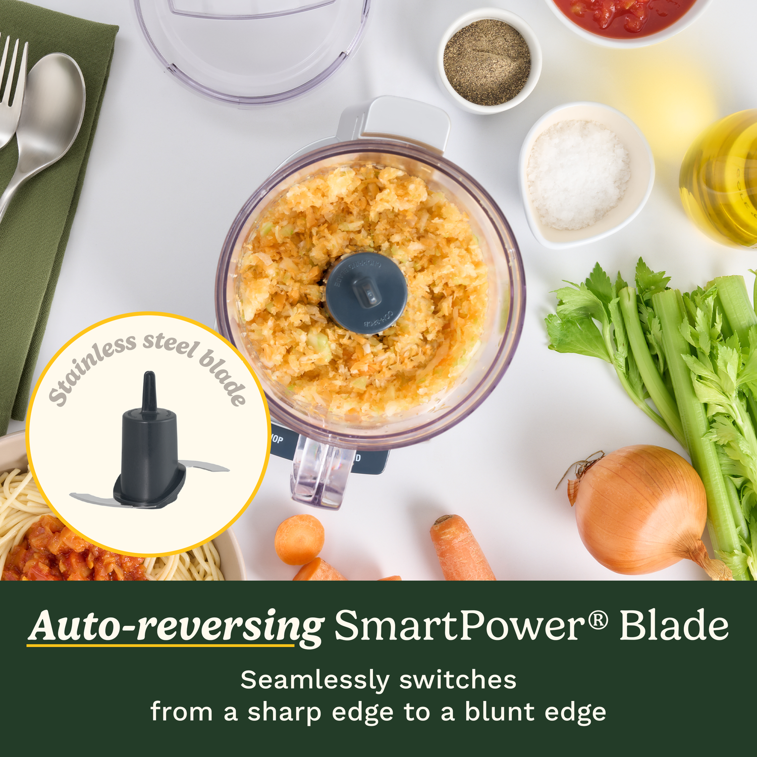 A food processor with vegetables inside and various ingredients such as salt, pepper, oil, tomatoes, and a stainless steel blade.