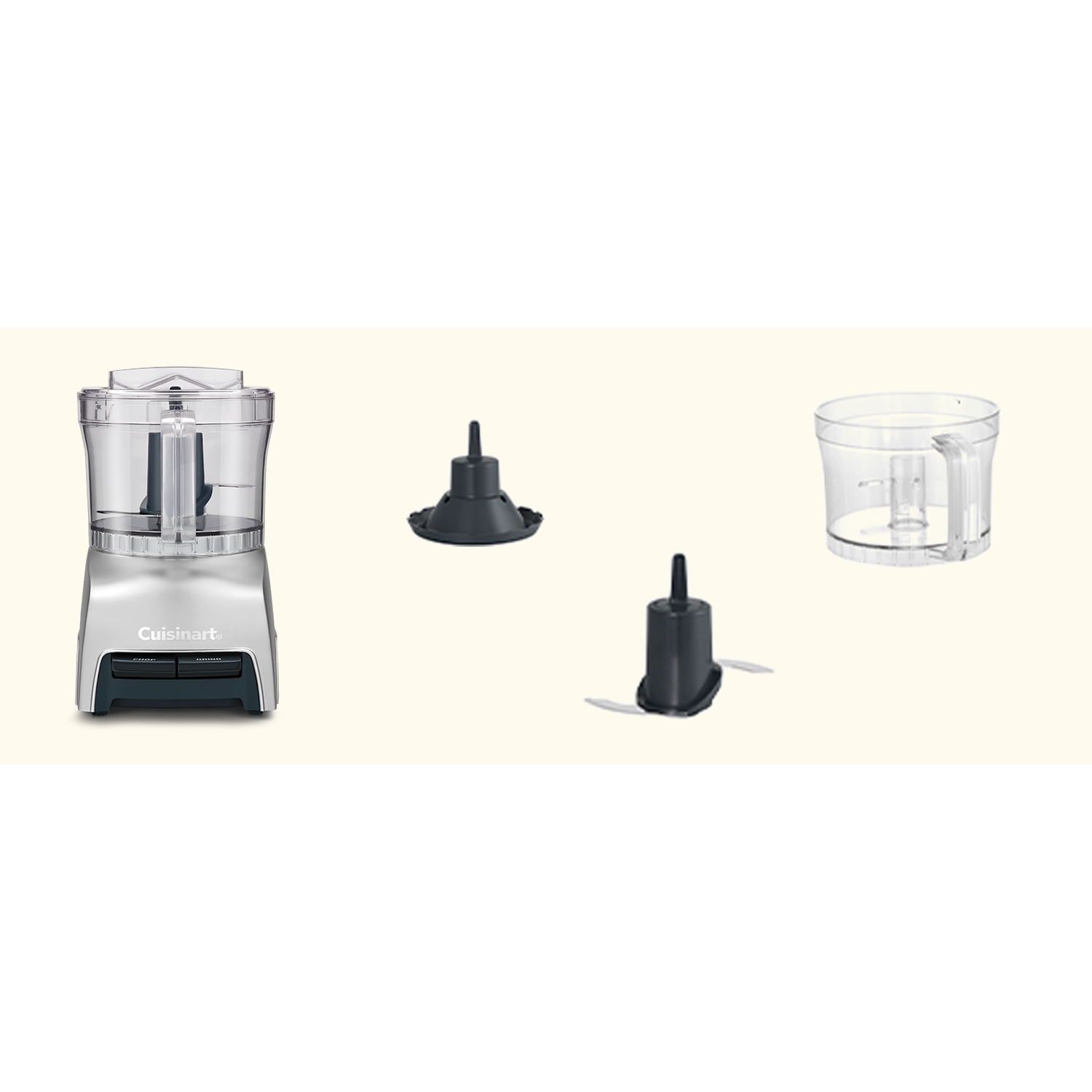 A Cuisinart food processor with parts. The food processor is silver with black accents. There are blades and a clear plastic bowl.