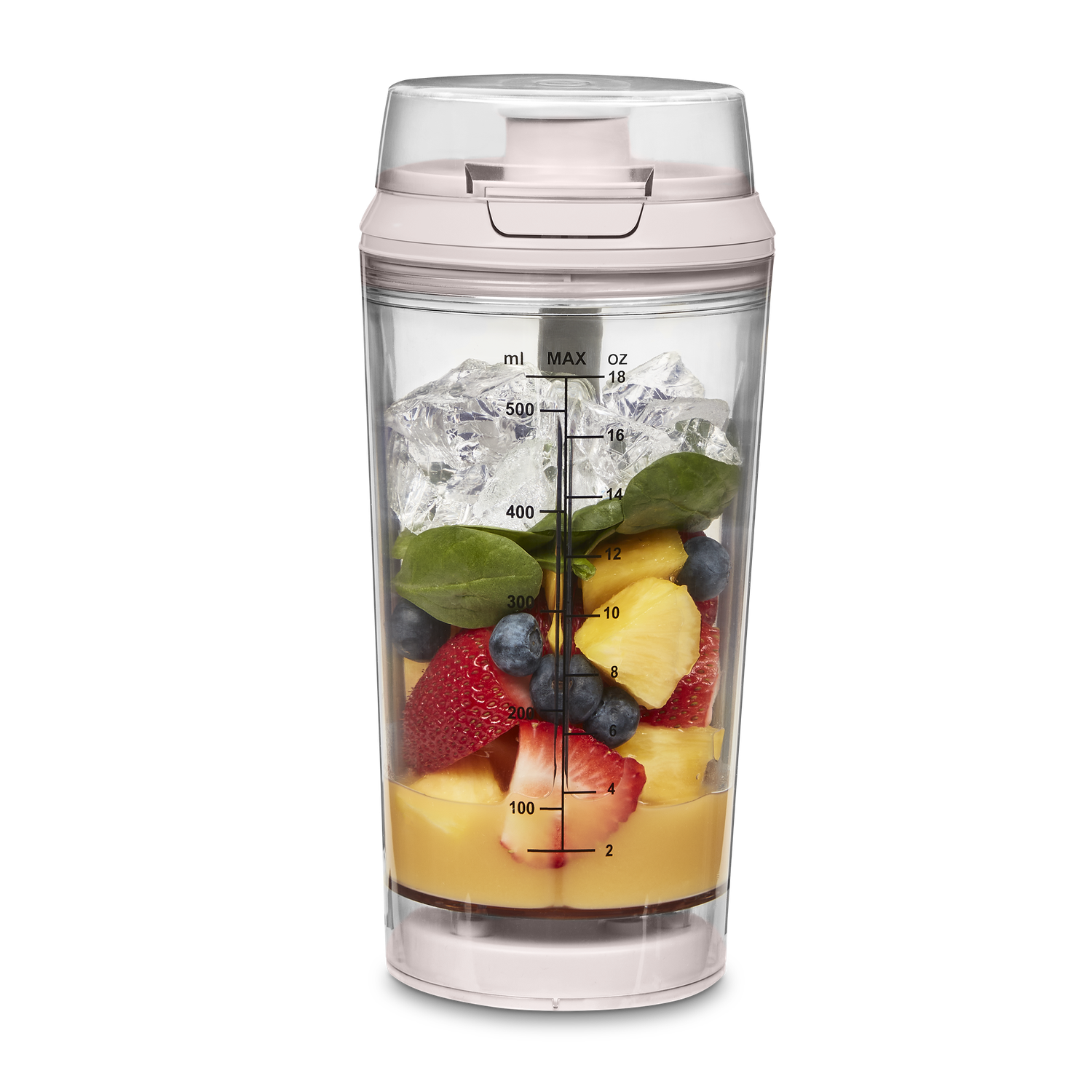 A blender cup with fruits and ice. Strawberries, blueberries, pineapple, and spinach are visible.