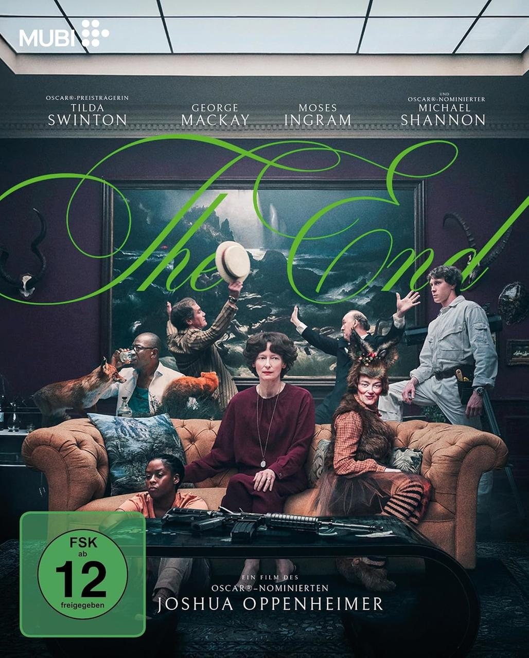 Filmposter mit Schauspielern und dem Titel 'The End'. Personen sitzen auf einem Sofa, mit einer Waffe im Vordergrund und einem Fuchs links.