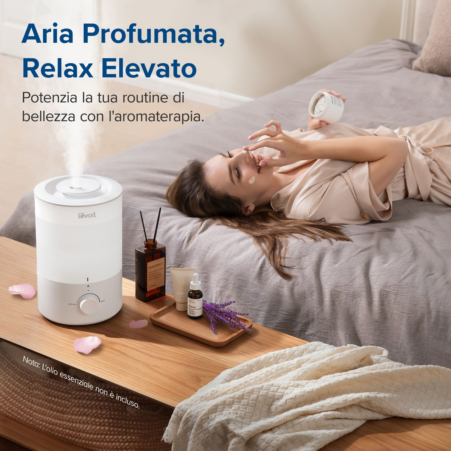 Donna che applica crema sul viso. Umidificatore e articoli di aromaterapia su un tavolo di legno. Testo: 'Aria Profumata, Relax Elevato'.