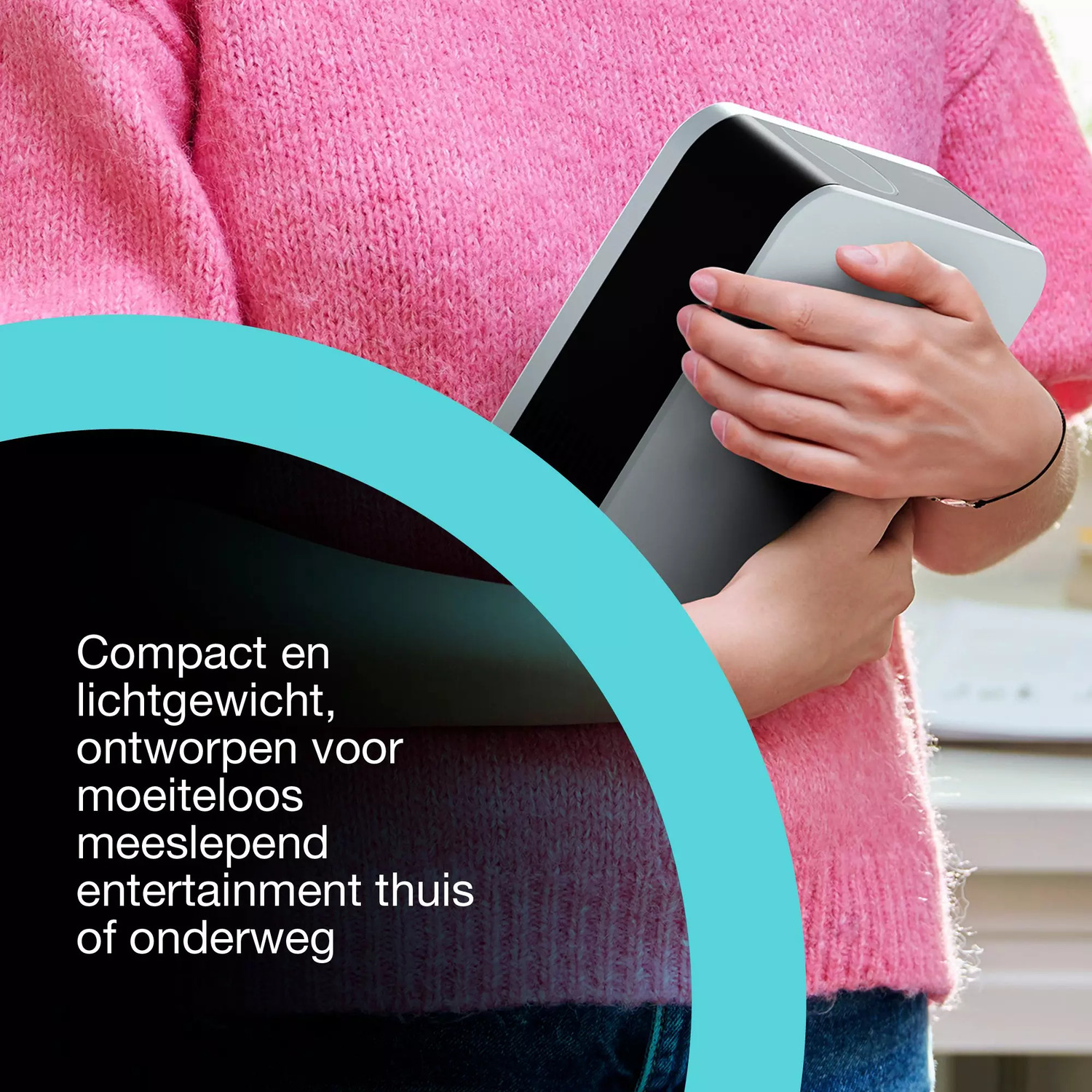 Een persoon in een roze trui houdt een grijs apparaat vast. De achtergrond toont een wazig interieur. Tekst: 'Compact en licht'.