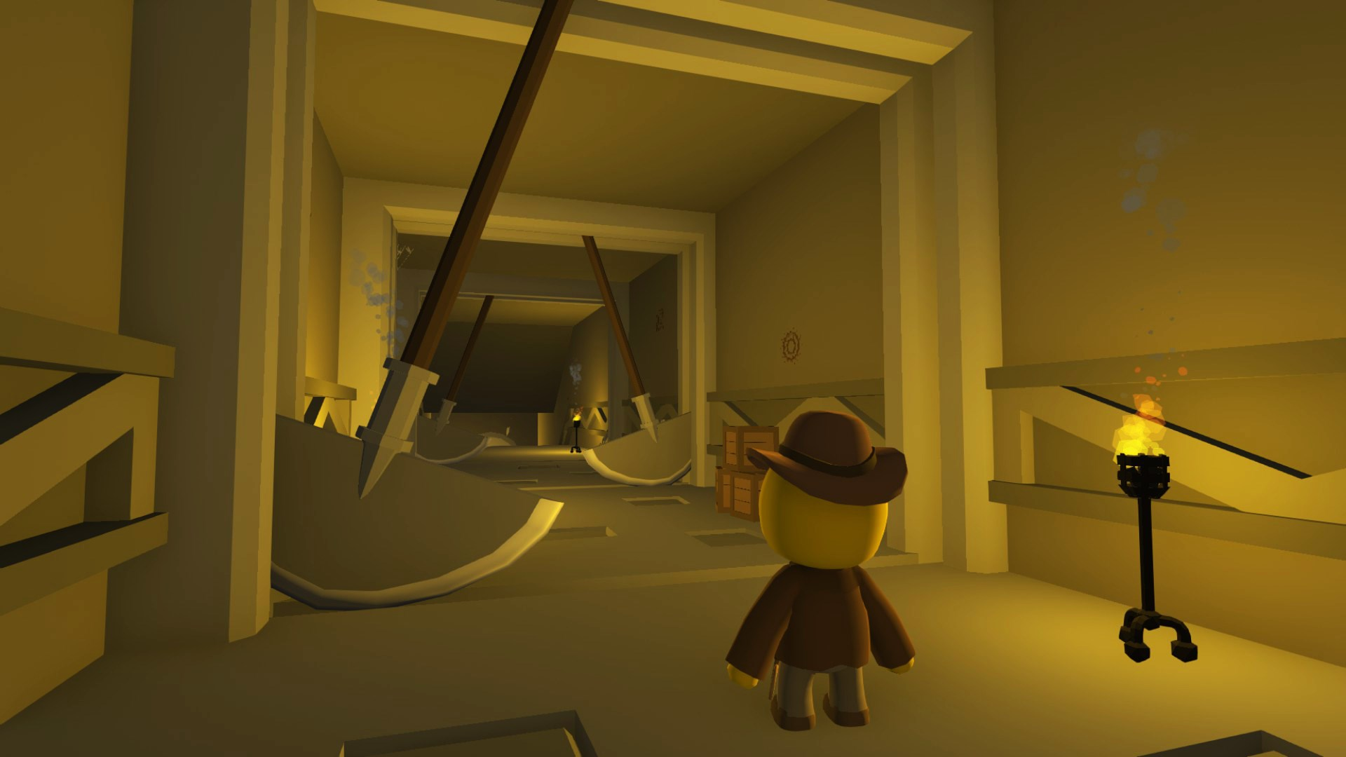 Un personnage jaune avec un chapeau et un manteau marron se tient dans une pièce avec de grandes pelles. Une torche brûle à droite.