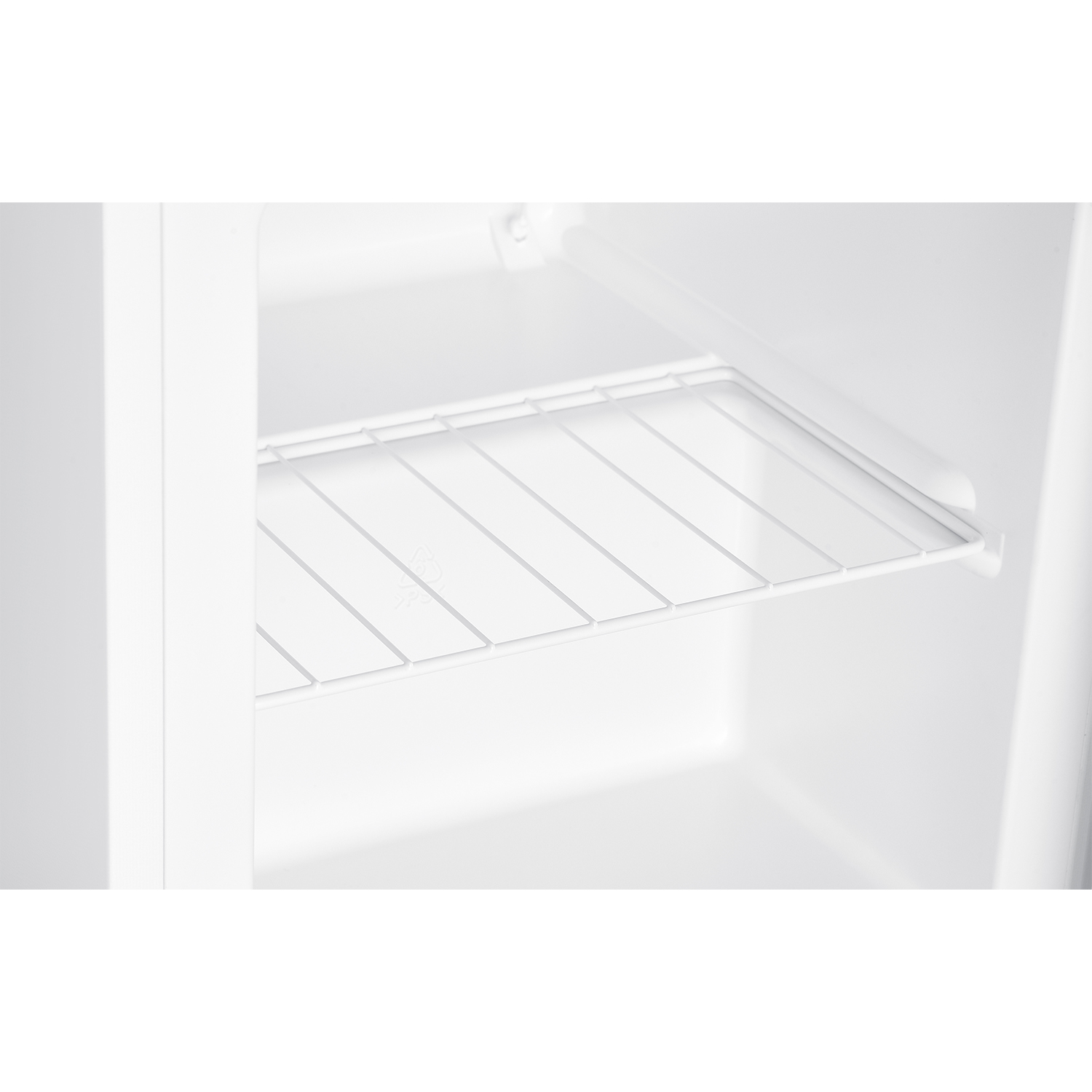 All'interno di un frigorifero bianco. Una mensola a filo è visibile all'interno del frigorifero vuoto. L'interno è bianco, la mensola è bianca.