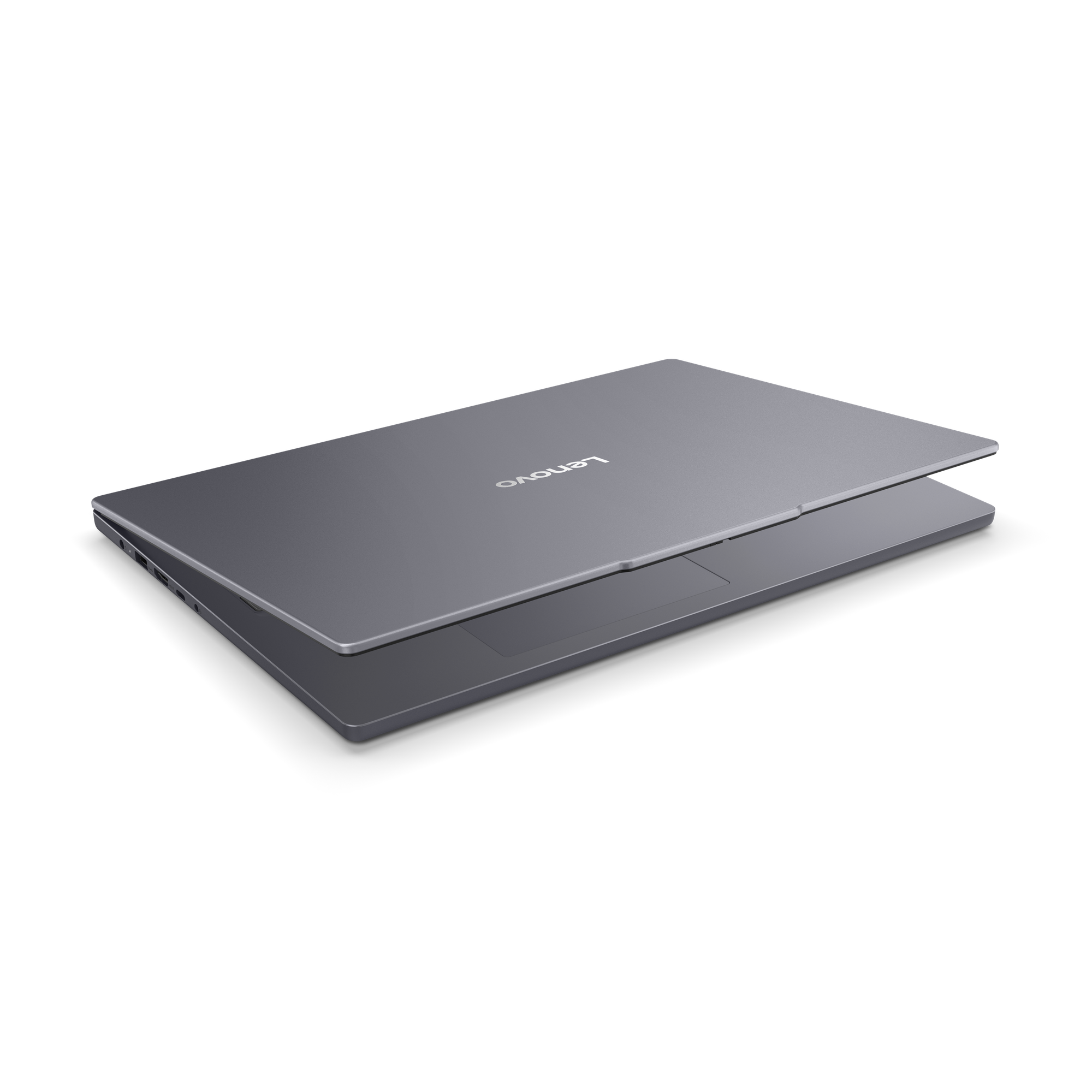 Un ordinateur portable Lenovo gris, légèrement ouvert sur fond noir. Le nom de la marque est visible.