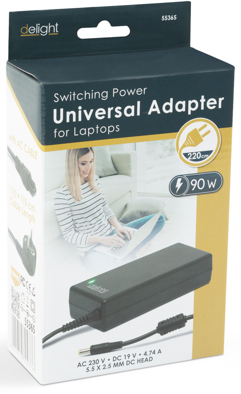 Doboz laptop adapterrel. Egy nő laptopot használ. Az adapternek van egy kábele, a dobozon adatok vannak.