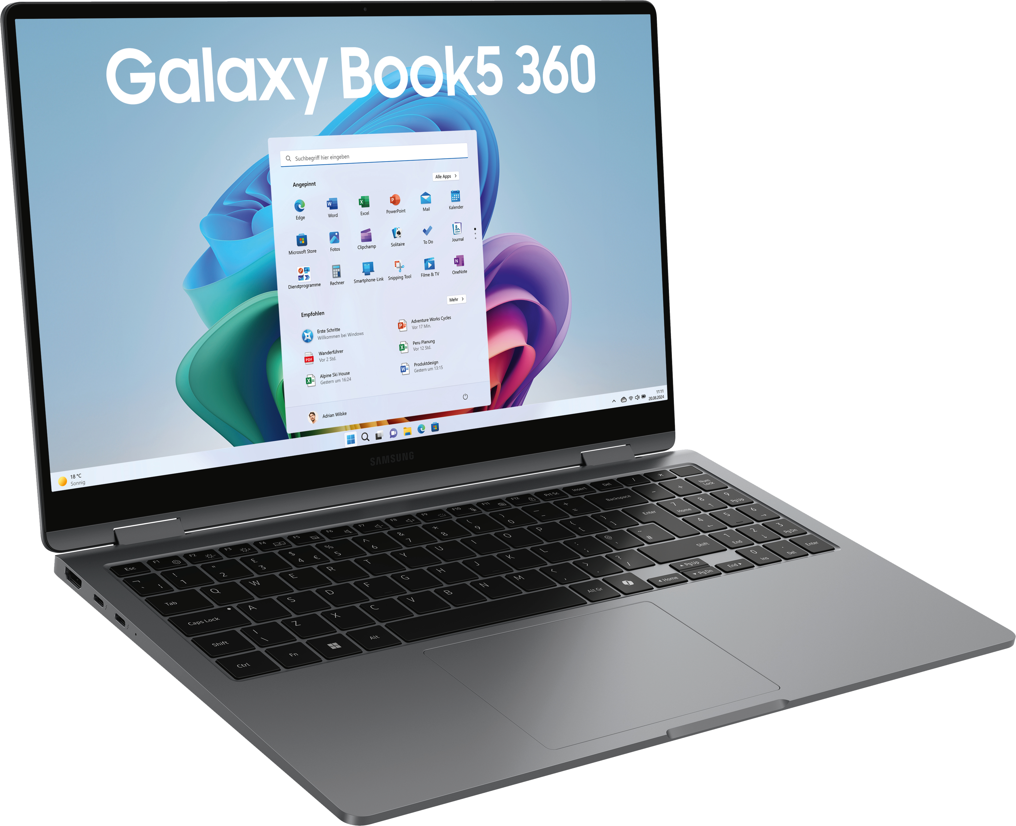 Ein silbernes Galaxy Book 5 Laptop ist geöffnet und zeigt eine Windows-Oberfläche mit App-Symbolen. Die Tastatur ist sichtbar.