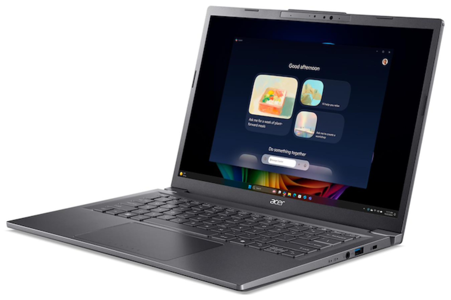 Una laptop Acer gris está abierta, mostrando una interfaz azul oscuro con sugerencias de aplicaciones. La pantalla dice 'Good afternoon'.